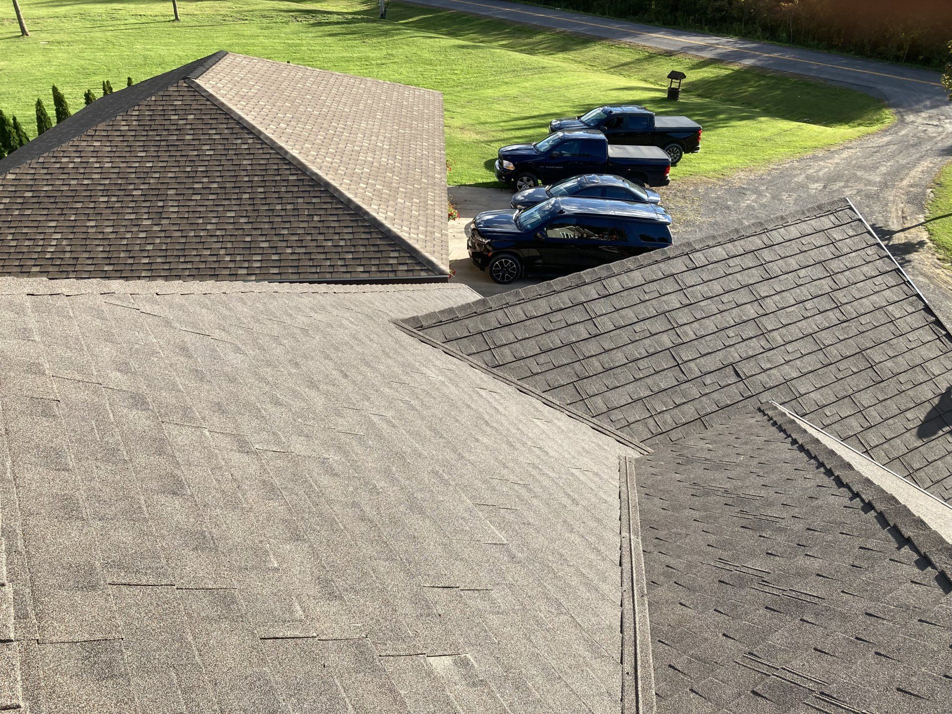 A row of trucks are parked on the roof of a house.
