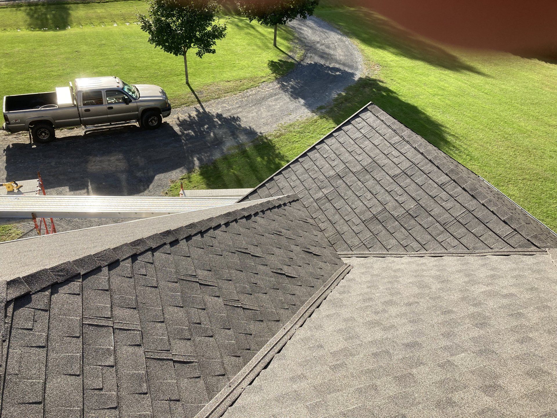 A truck is parked on the side of the road next to a roof.