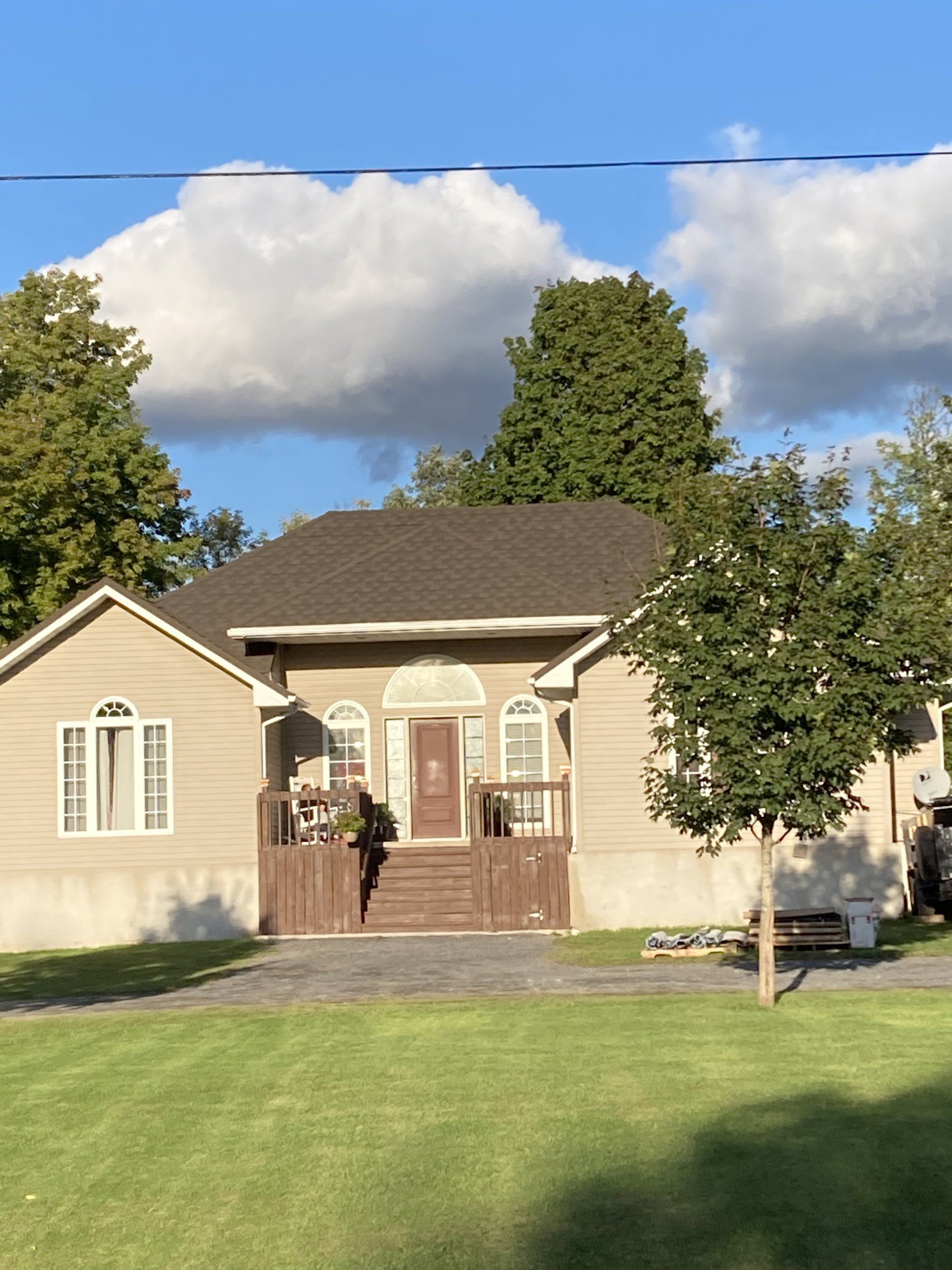 A house with a large lawn in front of it