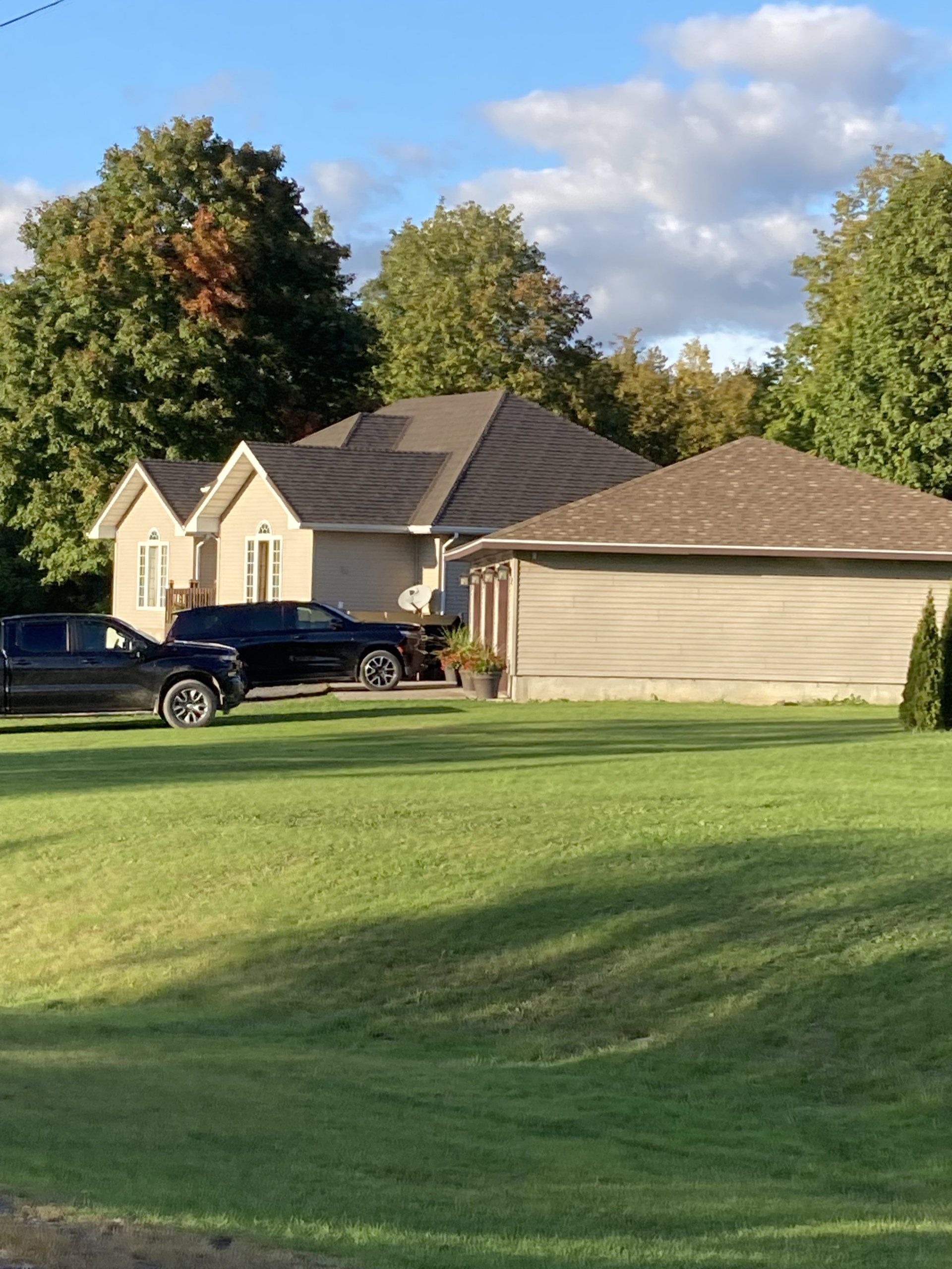A house with two cars parked in front of it
