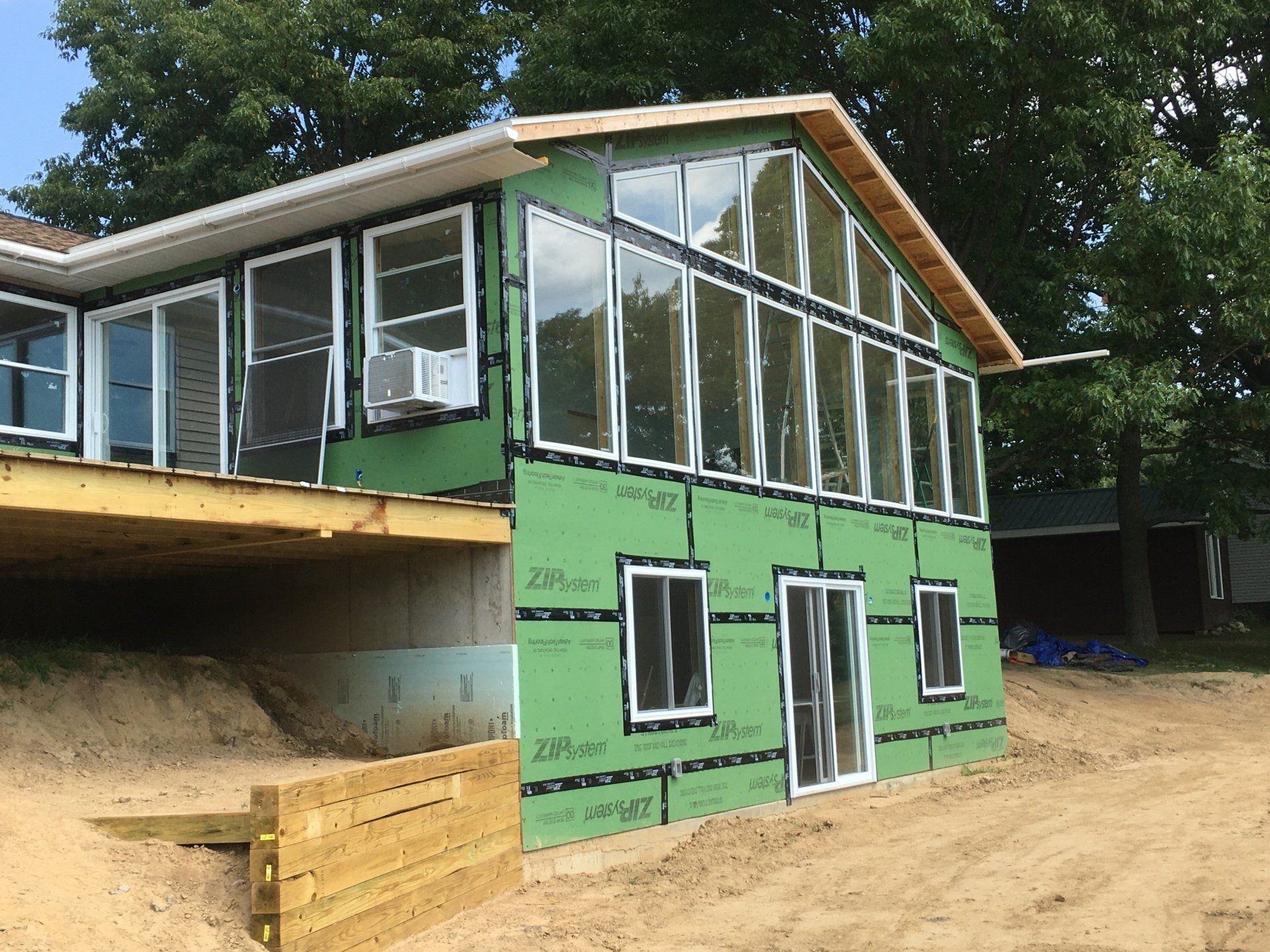 A house with a lot of windows is being built.