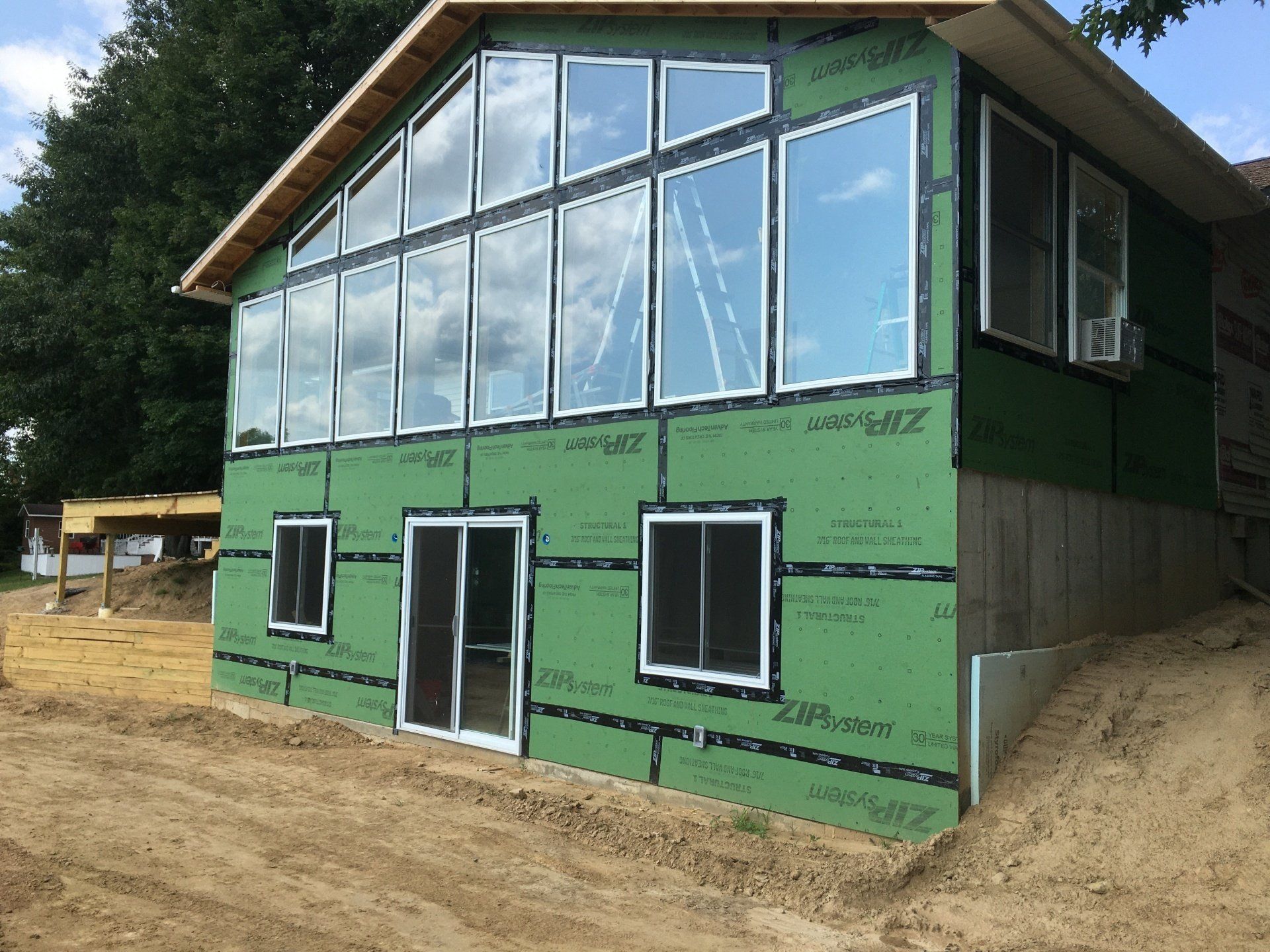 A house with a lot of windows is being built.