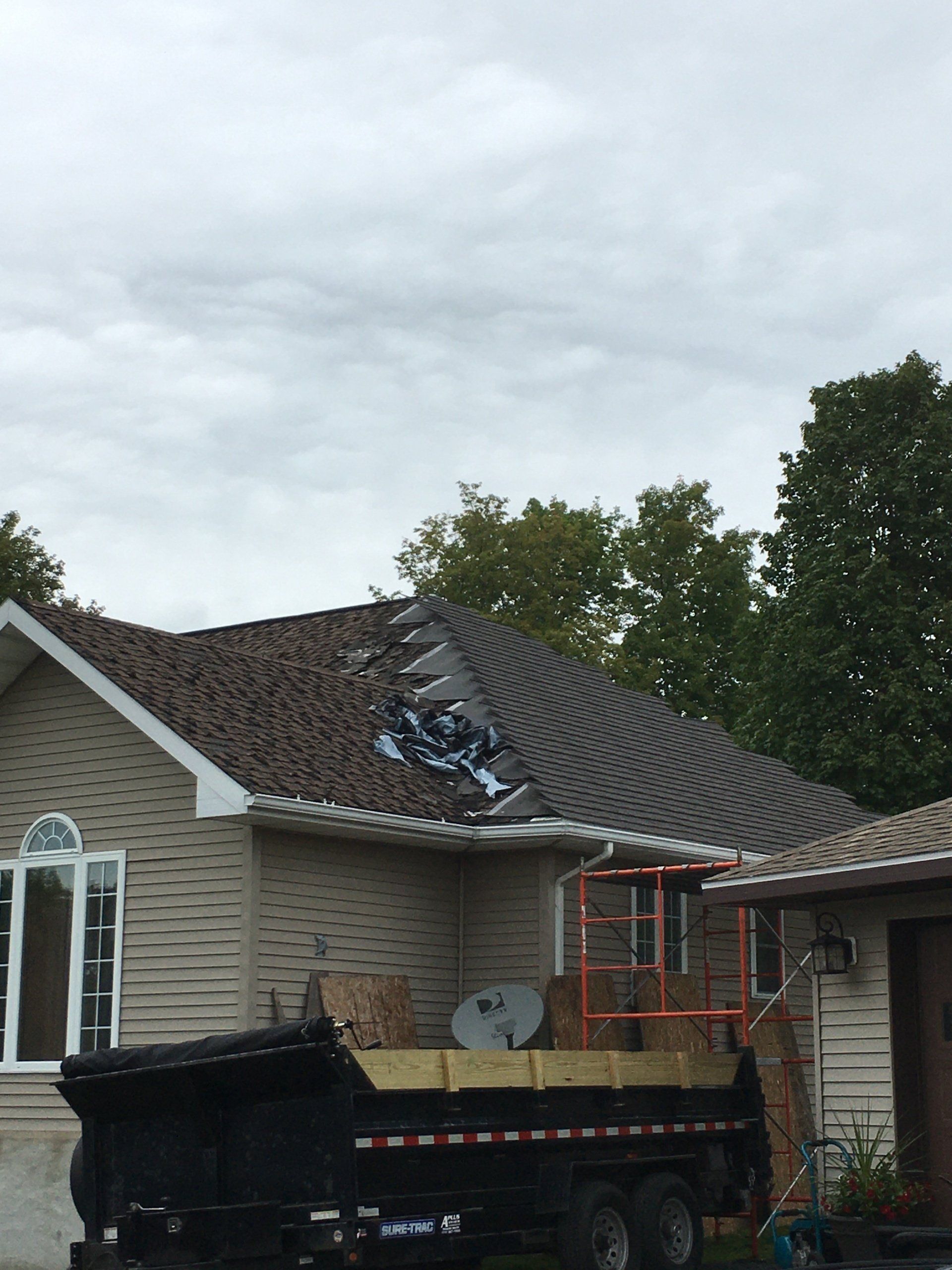A dump truck is parked in front of a house