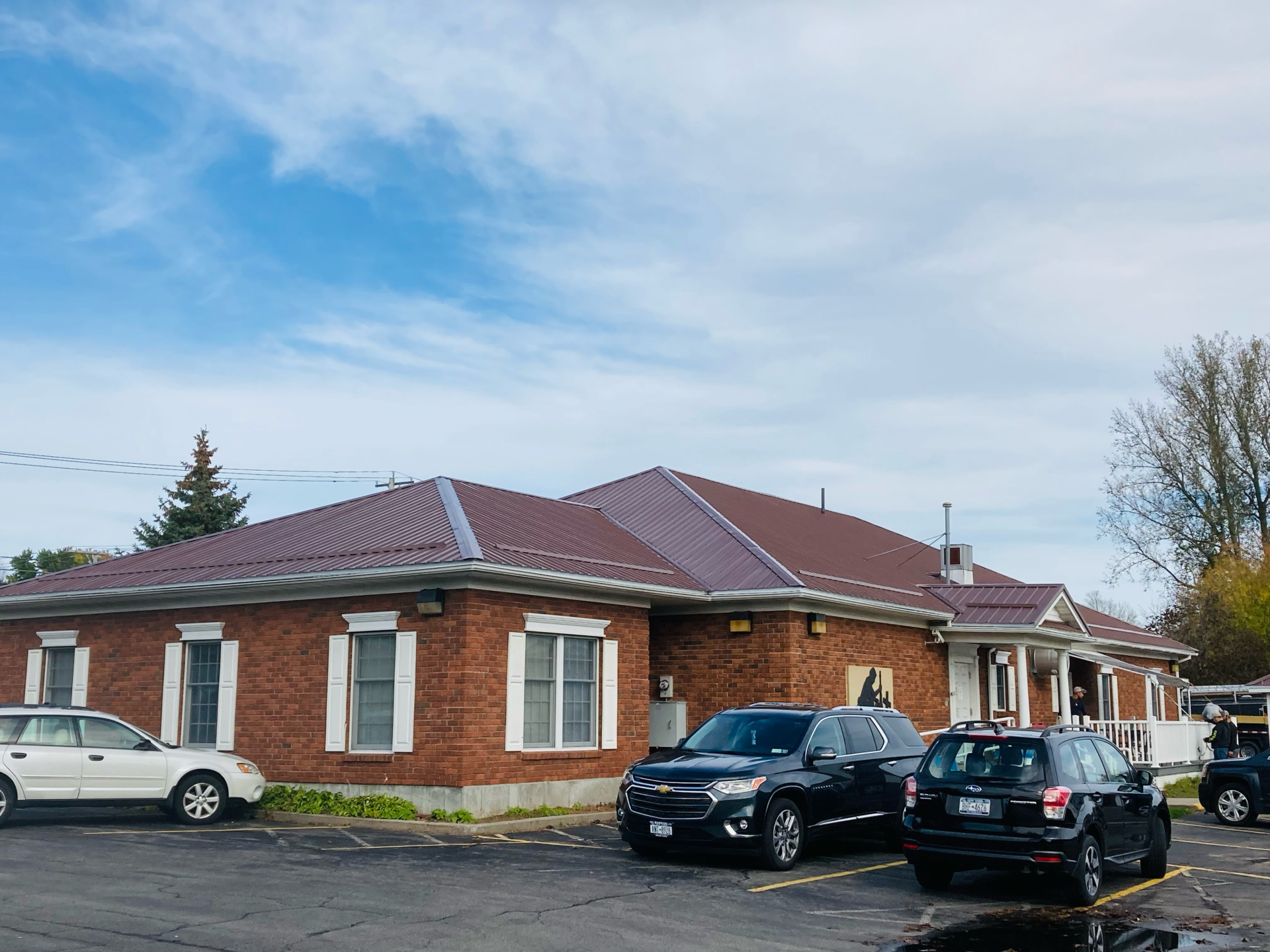 A brick building with cars parked in front of it