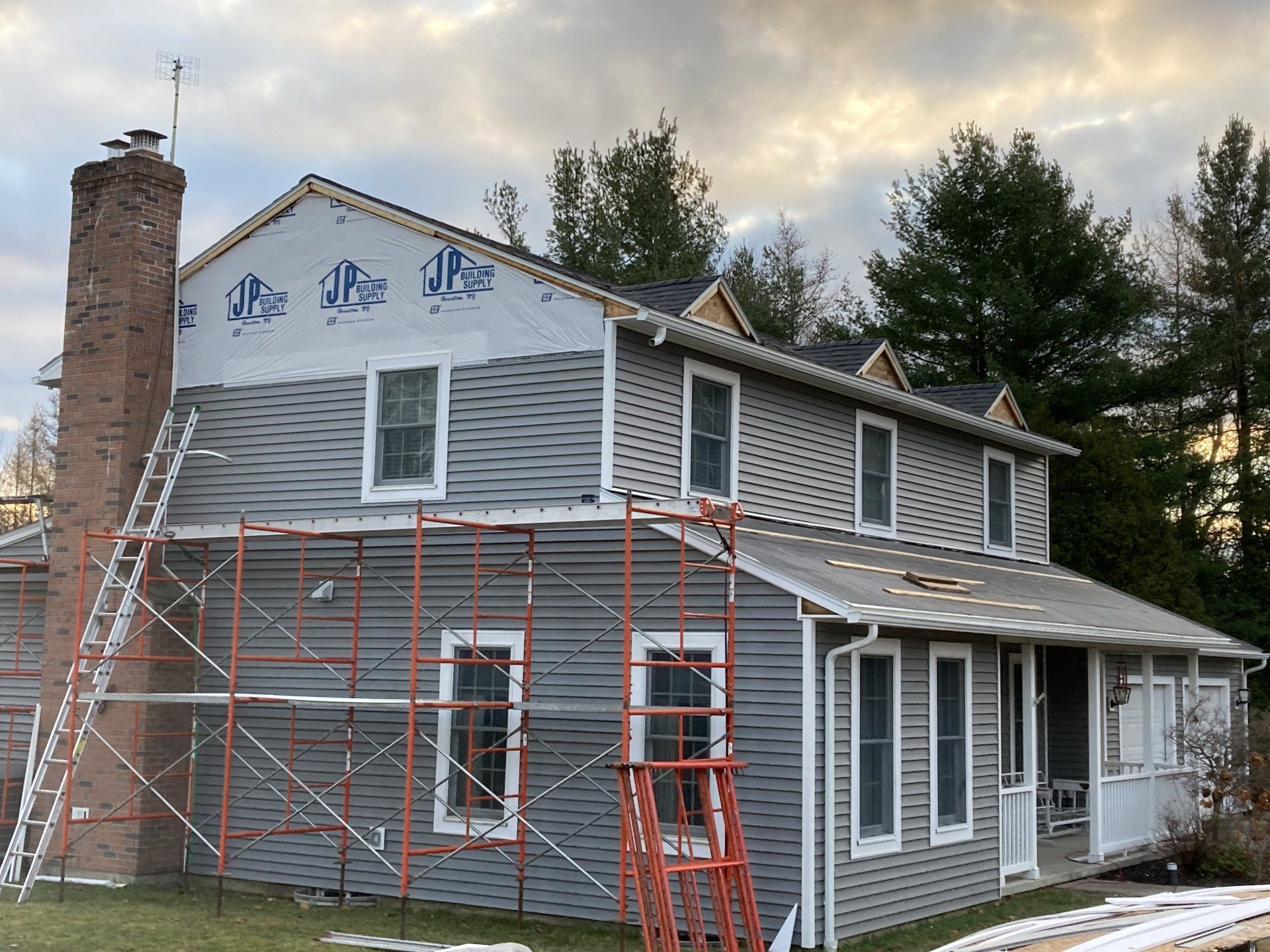A house with scaffolding around it is being remodeled.