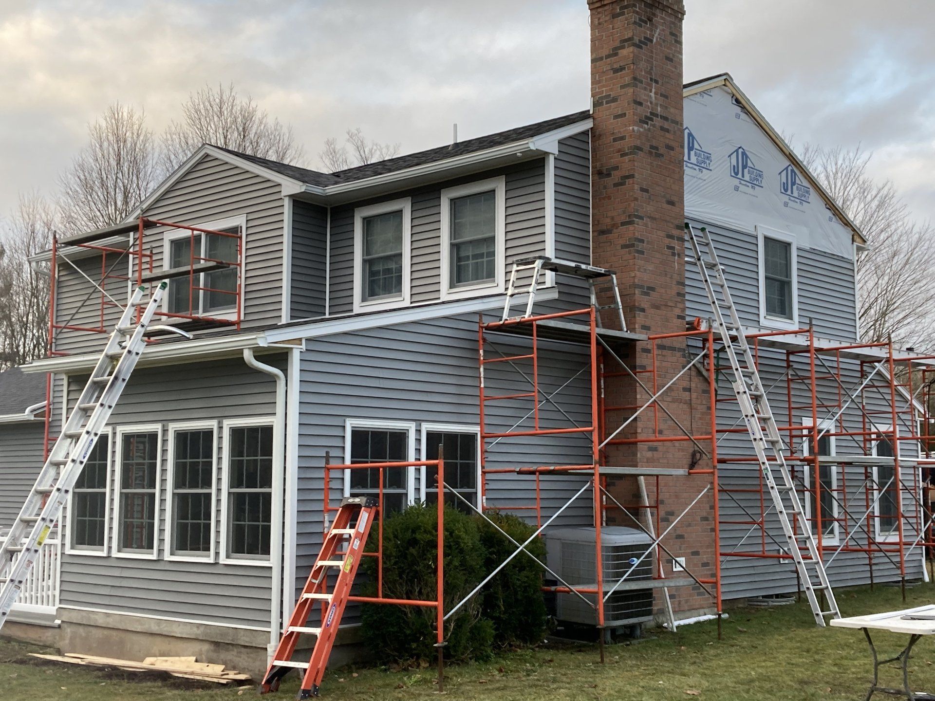 A house with scaffolding around it is being painted.