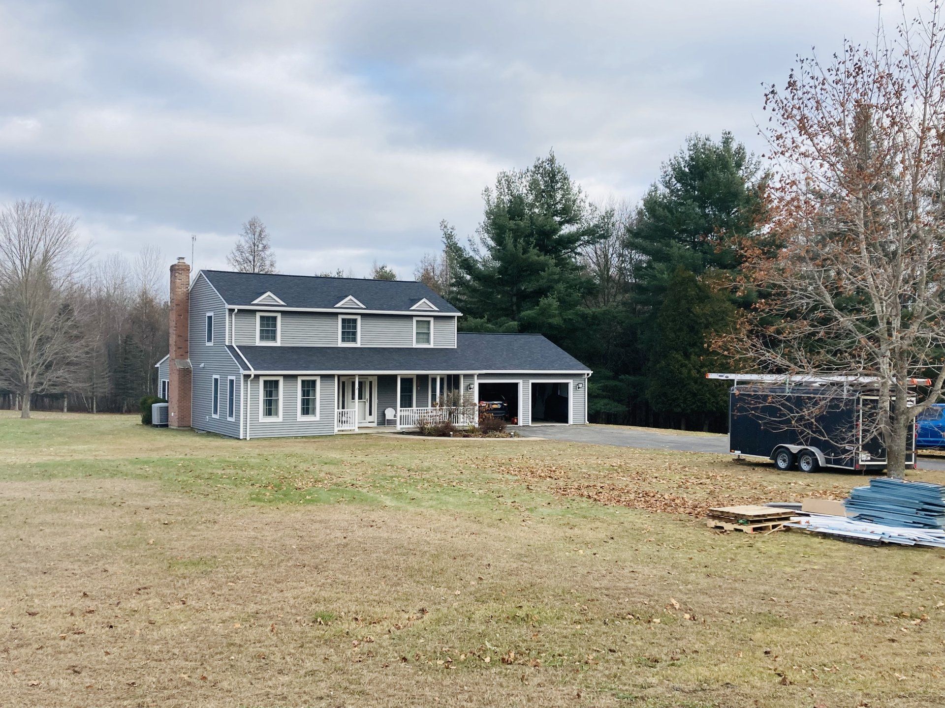 A large house is sitting in the middle of a grassy field.