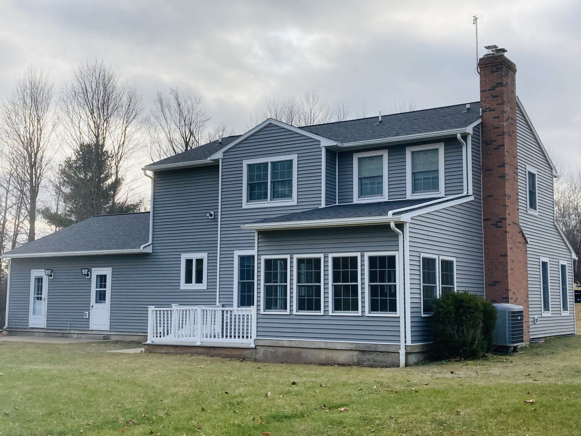 A large house with a lot of windows and a chimney