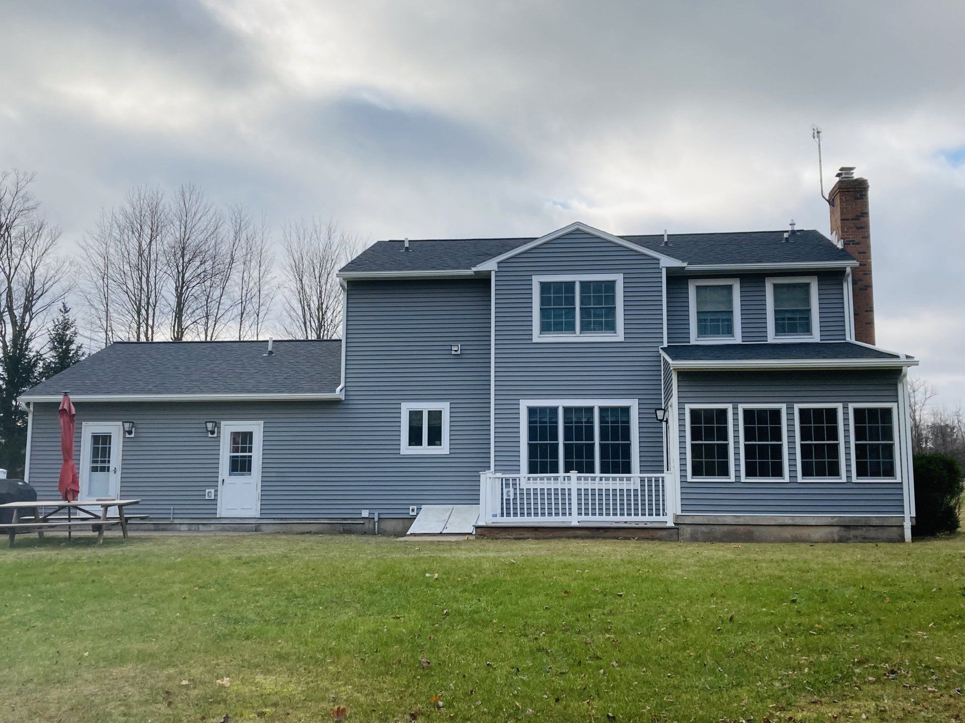A large house with a picnic table in front of it