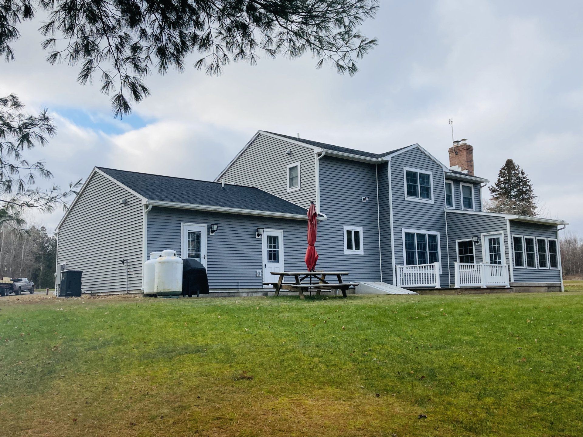A large house with a picnic table in front of it