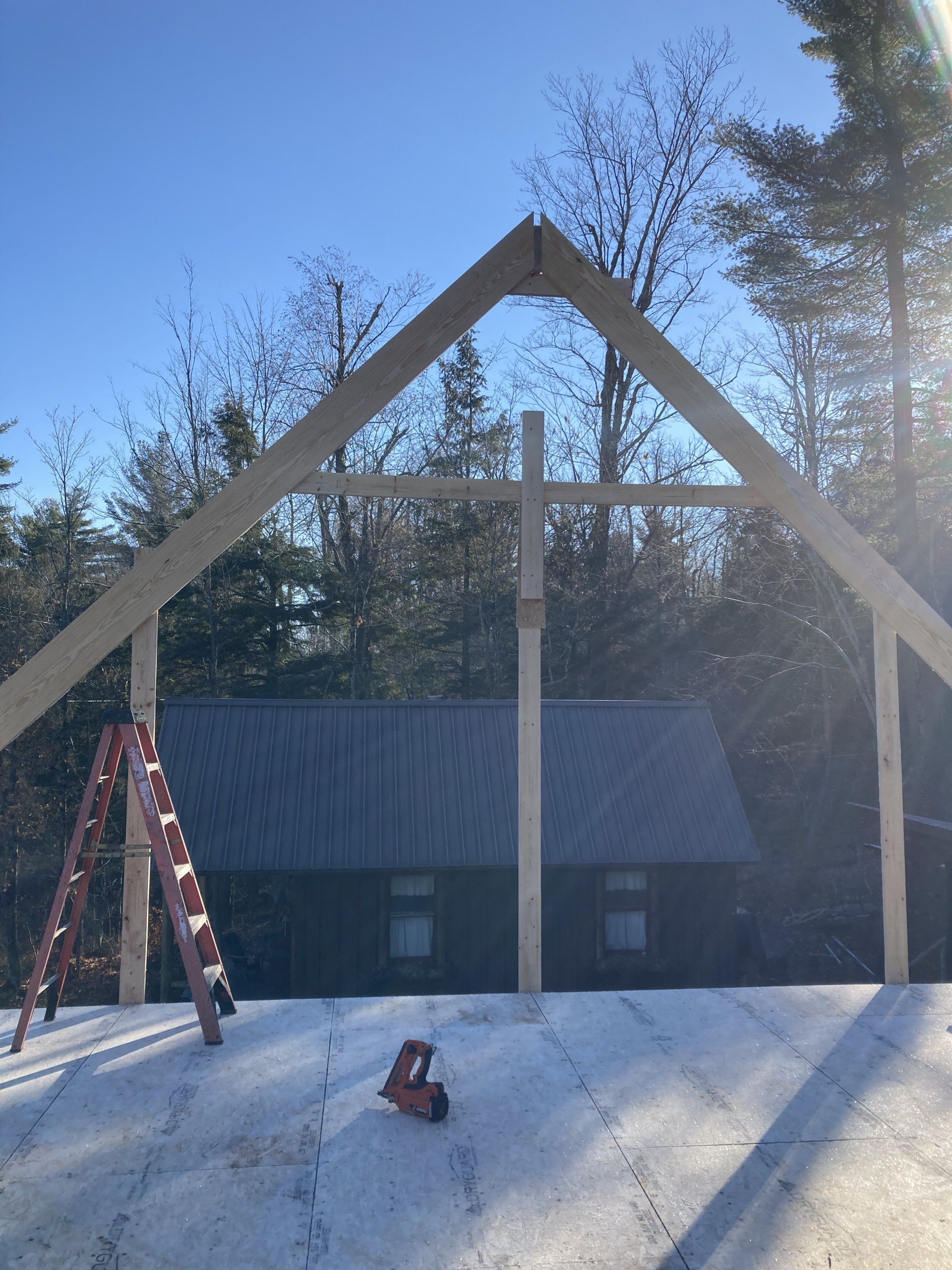 A wooden structure is being built in front of a house