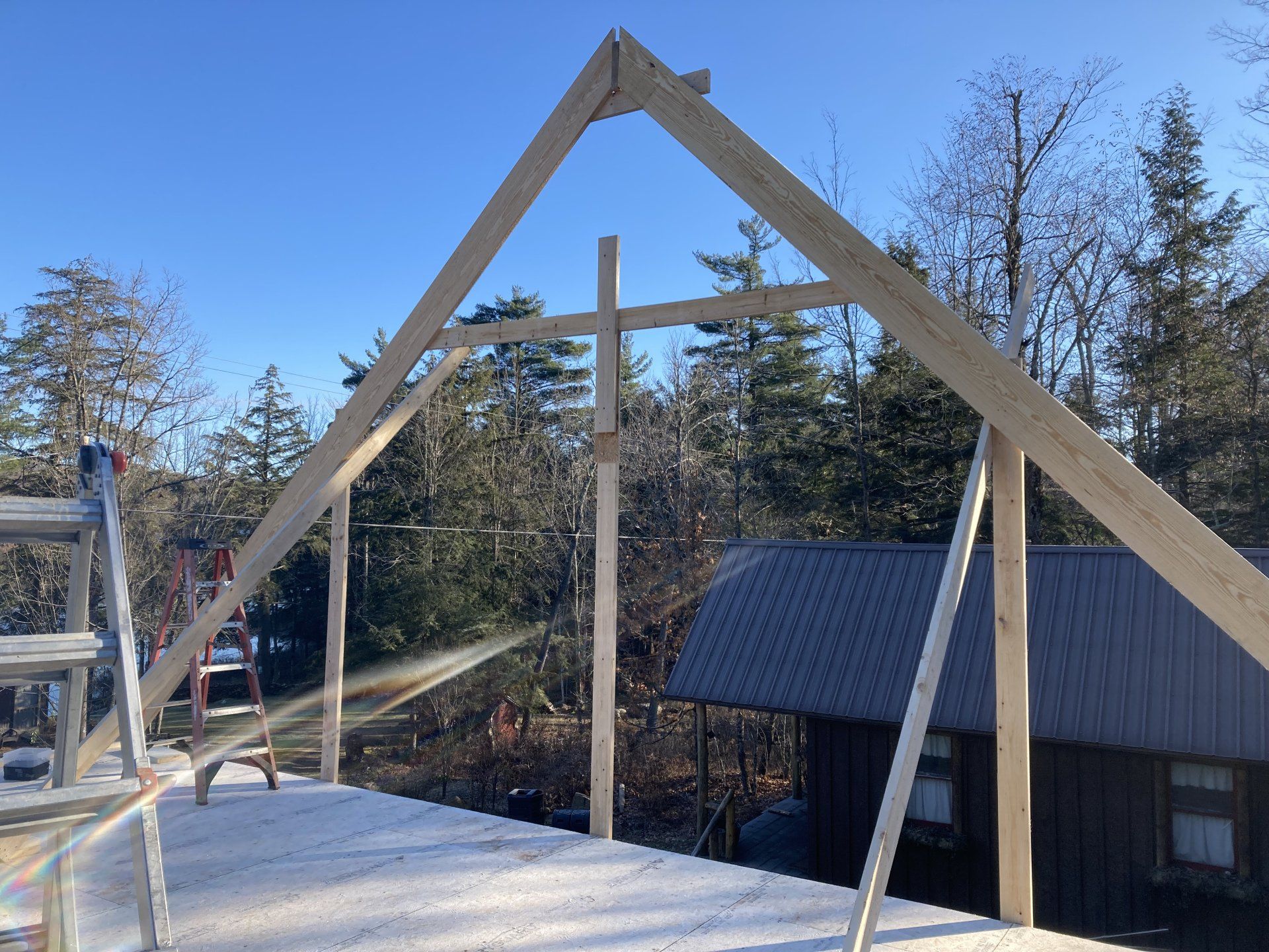 A wooden structure is being built in front of a house