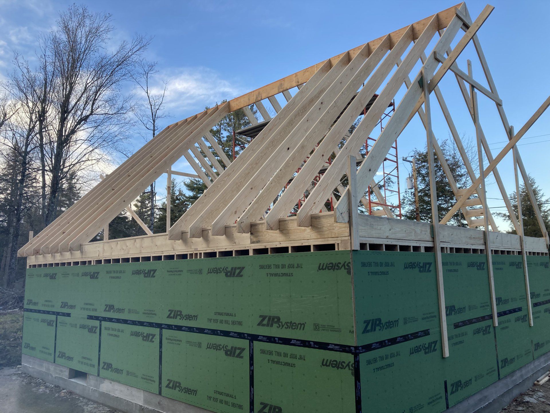 A house is being built with a wooden roof.
