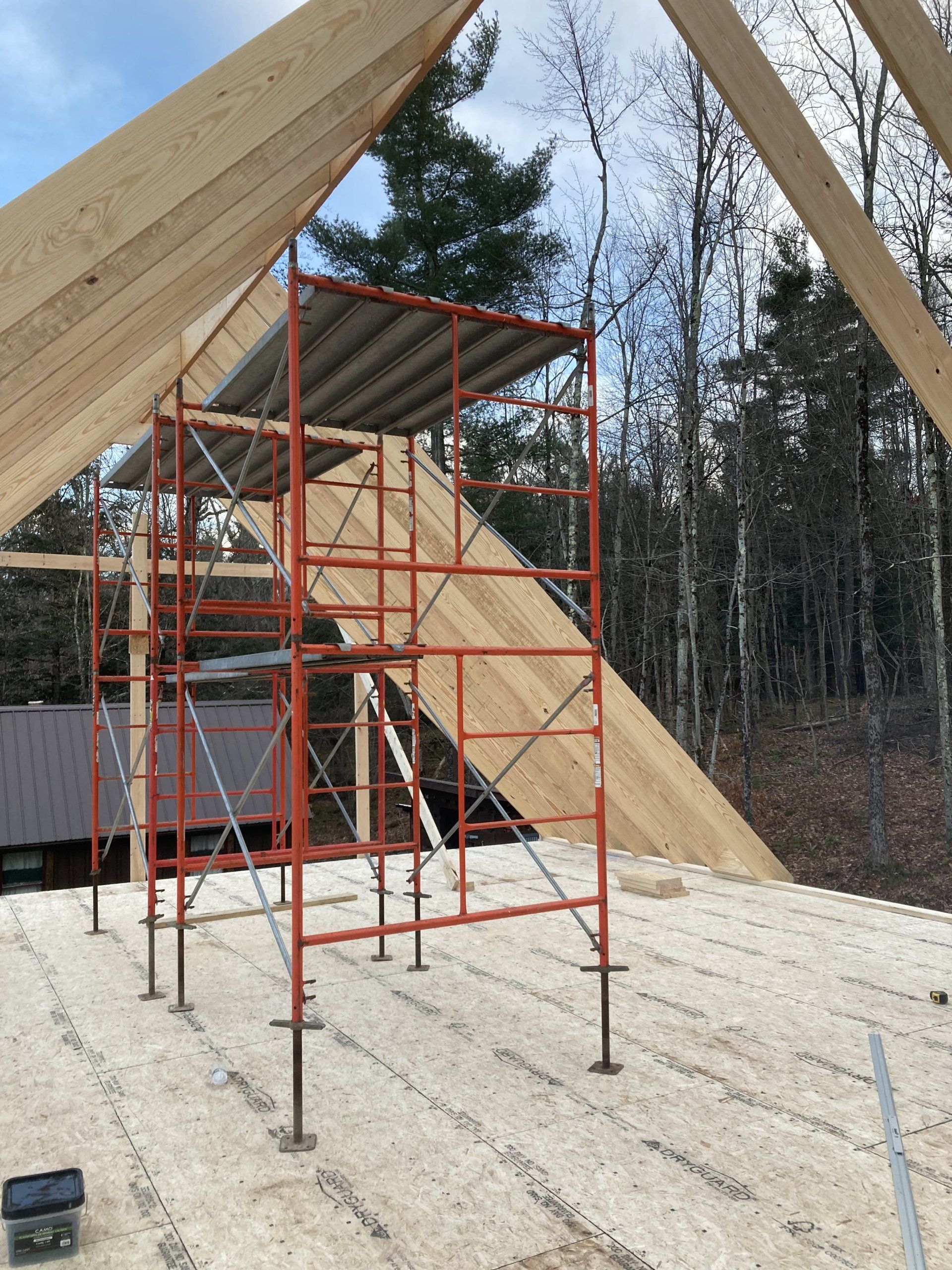 A roof is being built with scaffolding on the ground