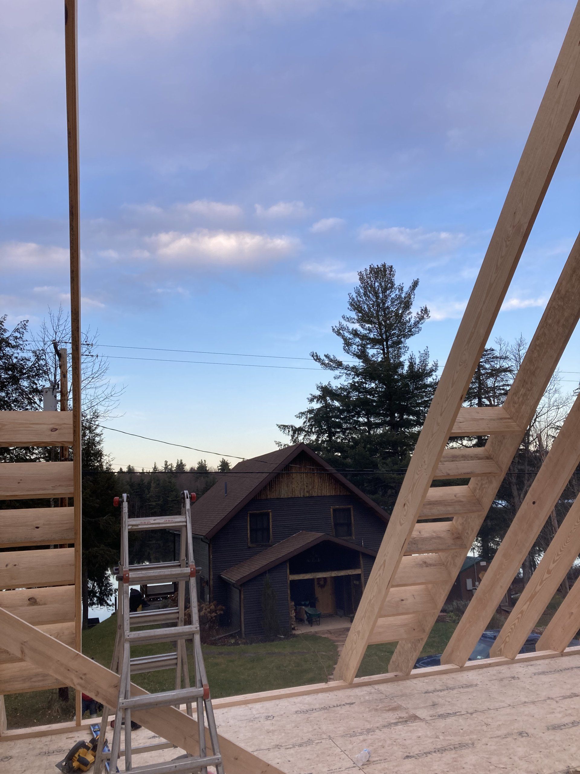 A house is being built with a ladder in the foreground