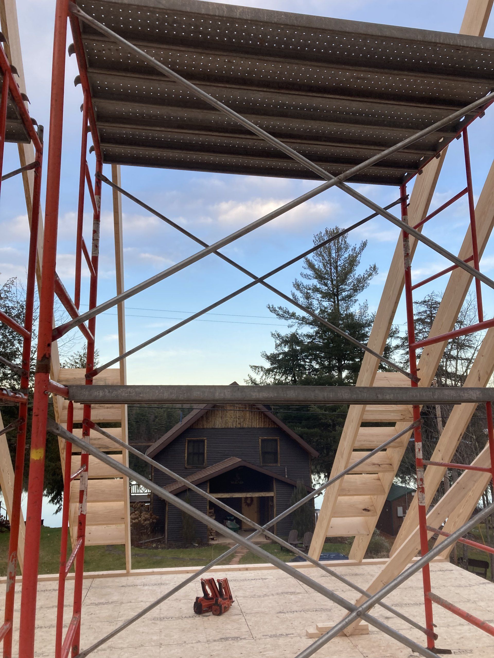 A scaffolding with a view of a house in the background