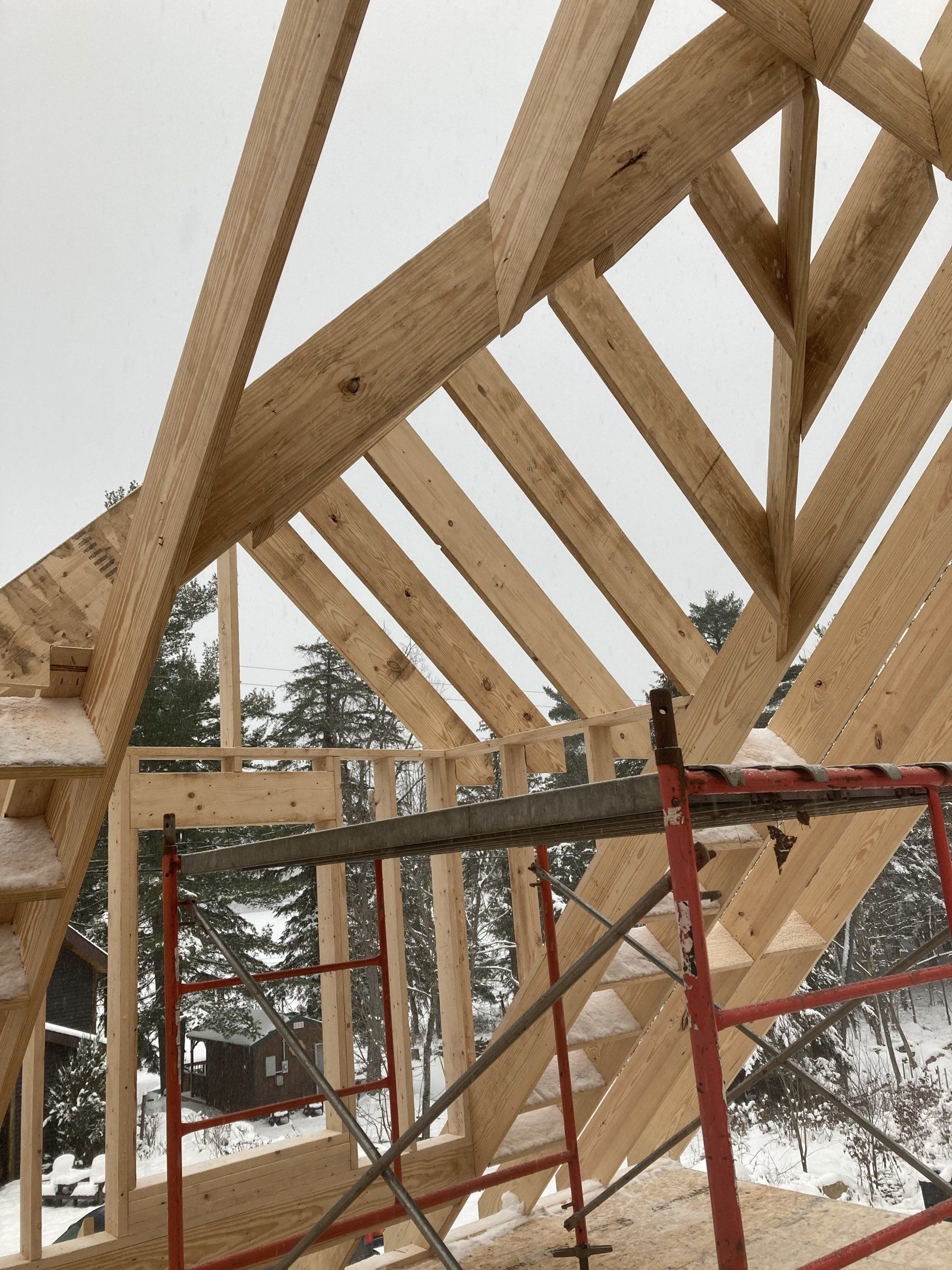A wooden structure is being built in the snow