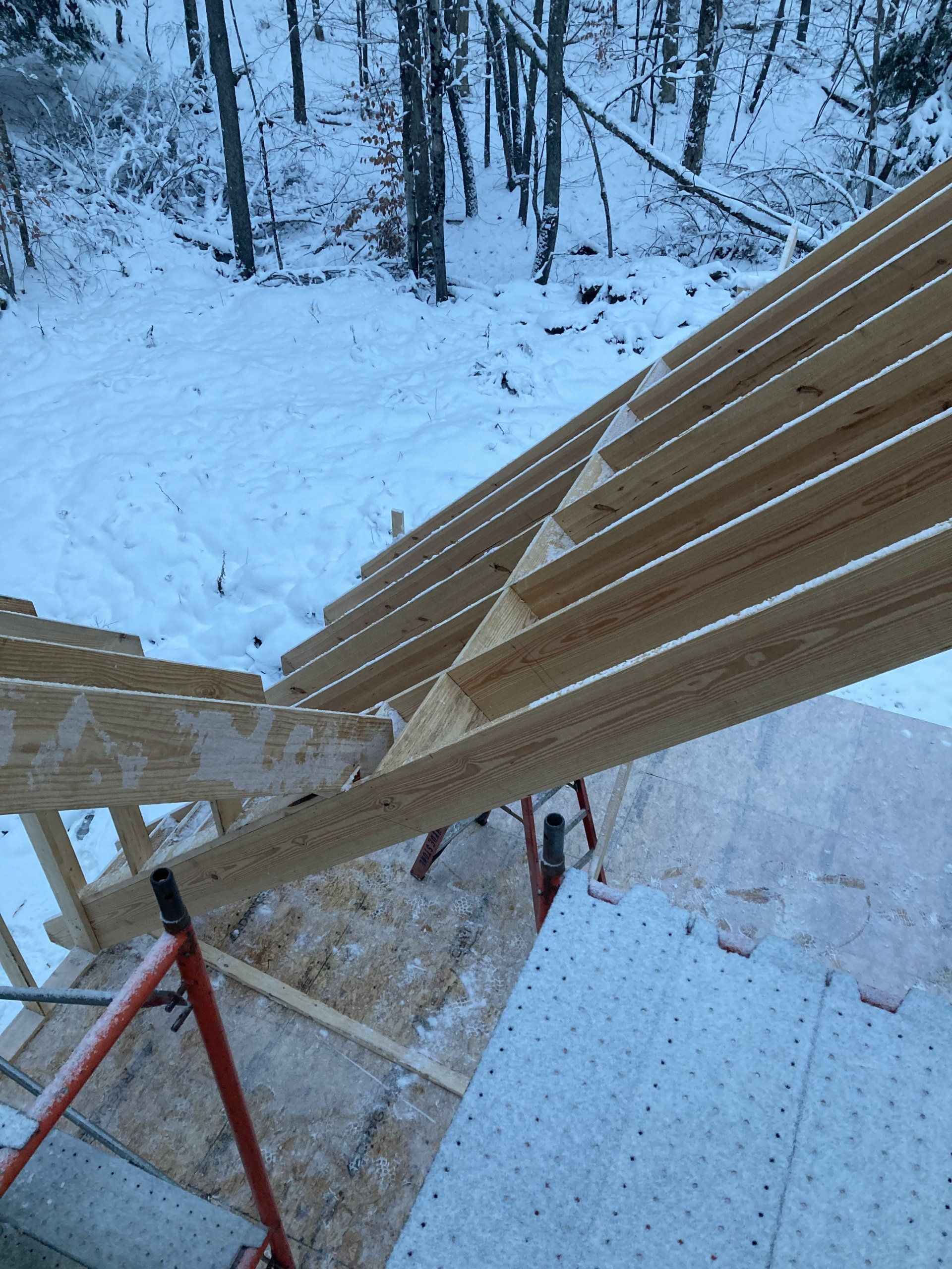 A wooden structure is being built in the snow