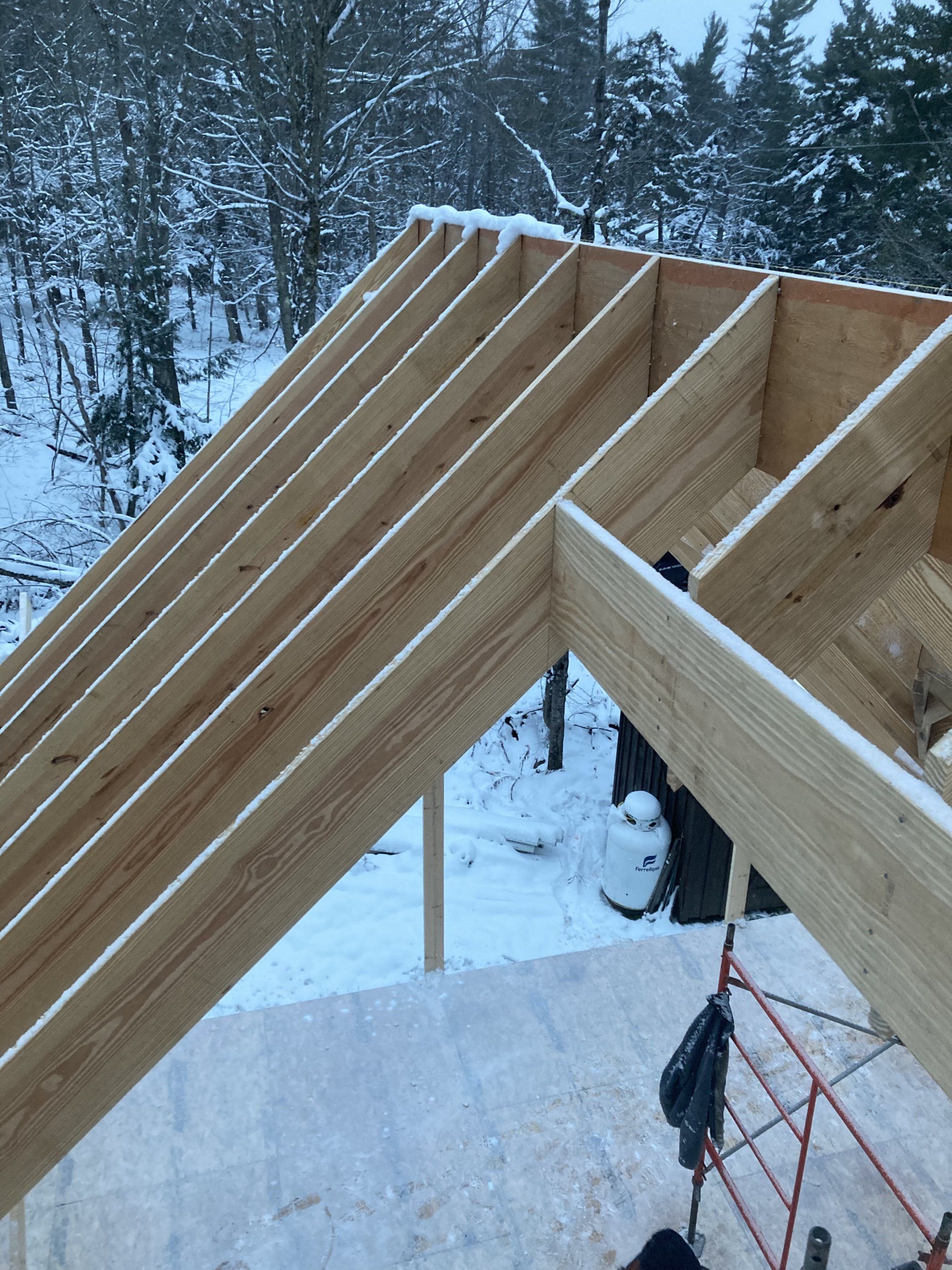 A wooden structure is being built in the snow