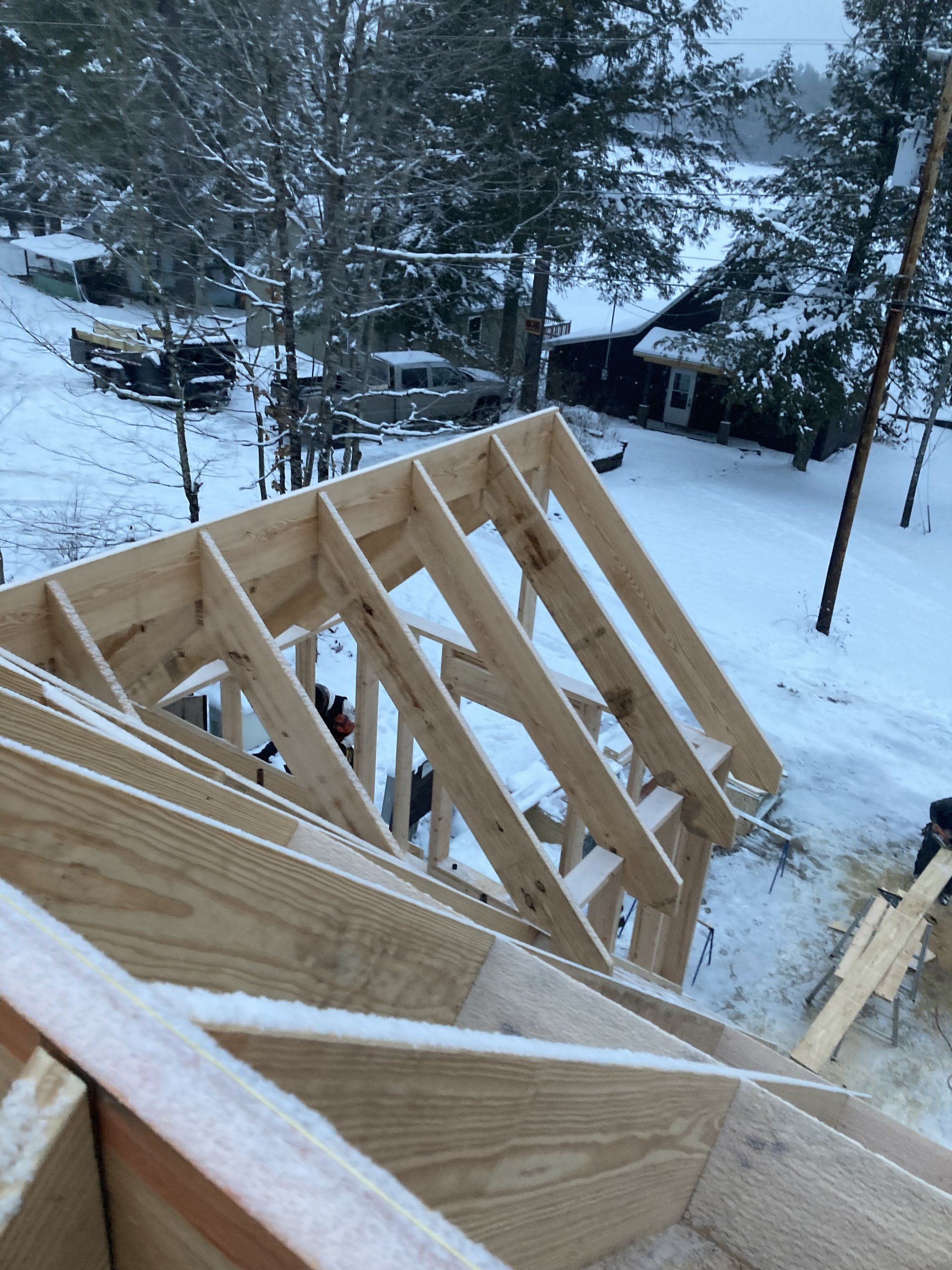 A wooden structure is being built in the snow