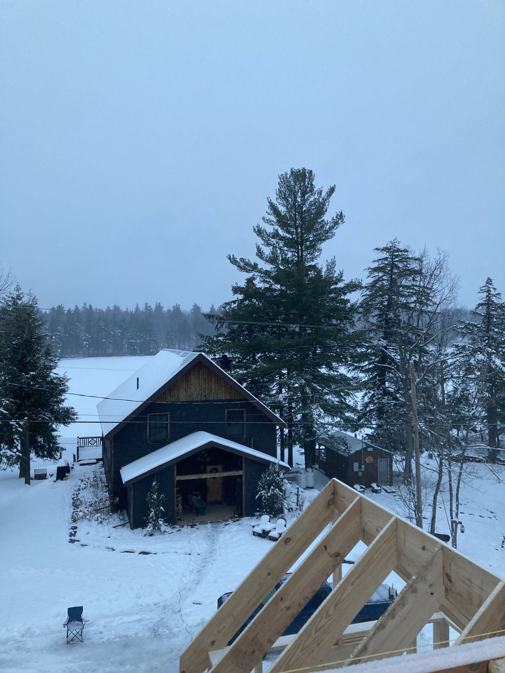 A snowy landscape with a house in the foreground