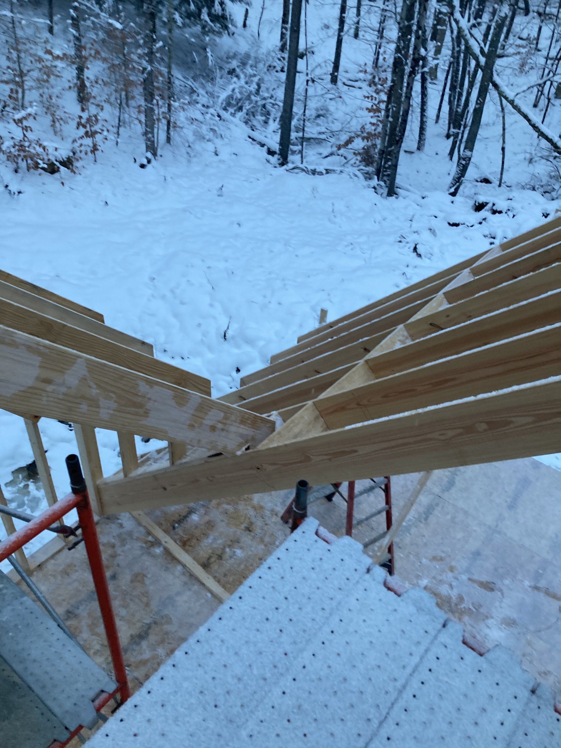 A wooden structure is being built in the snow