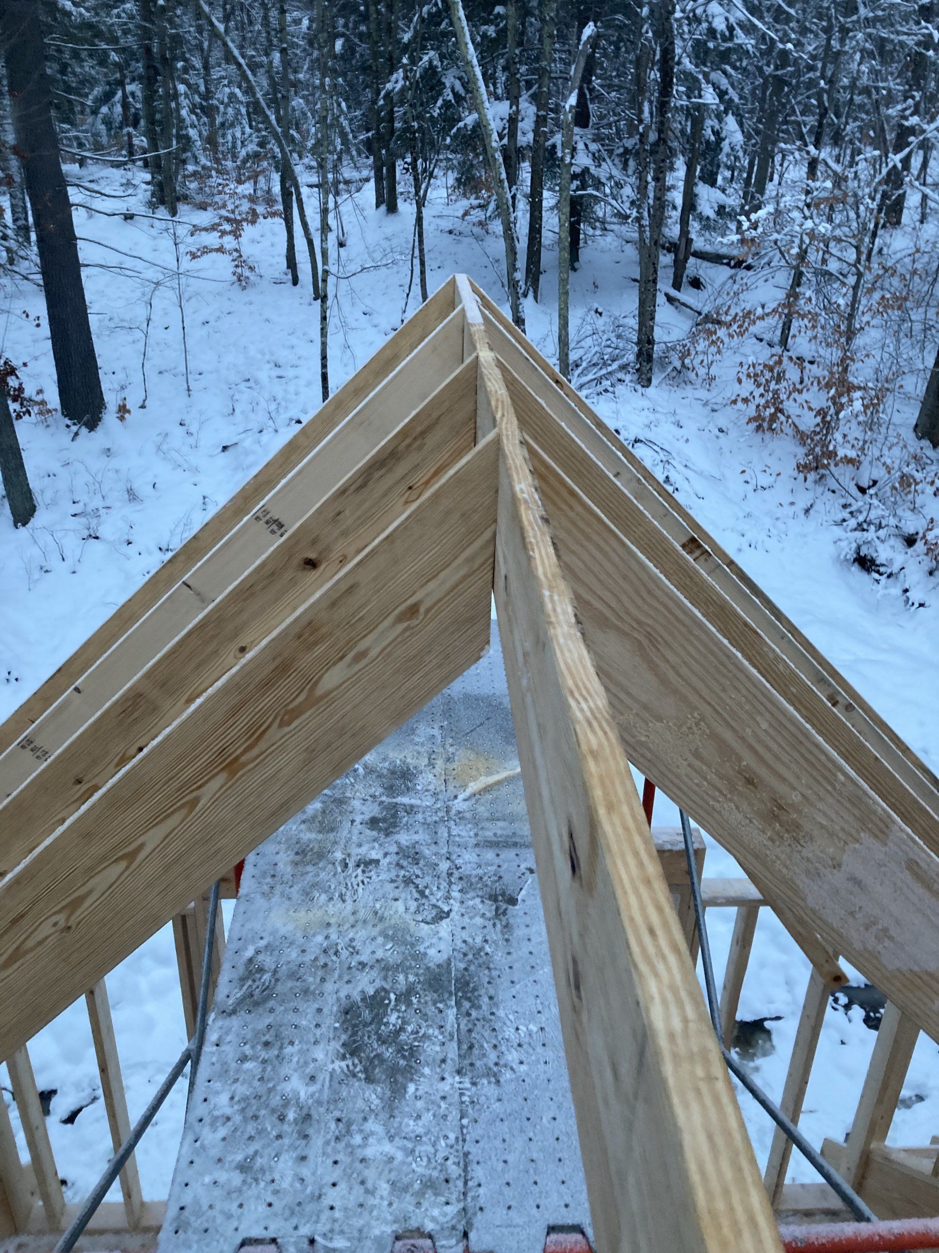 A wooden structure is being built in the snow