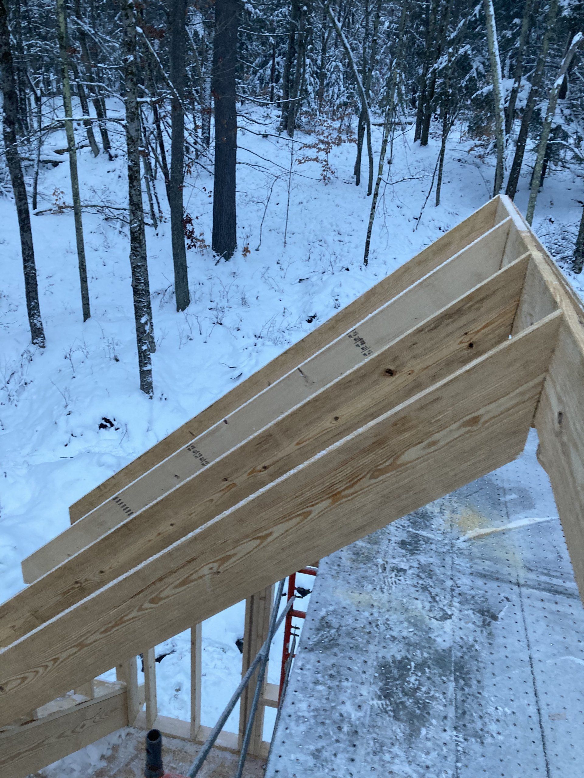 A wooden structure is being built in the snow