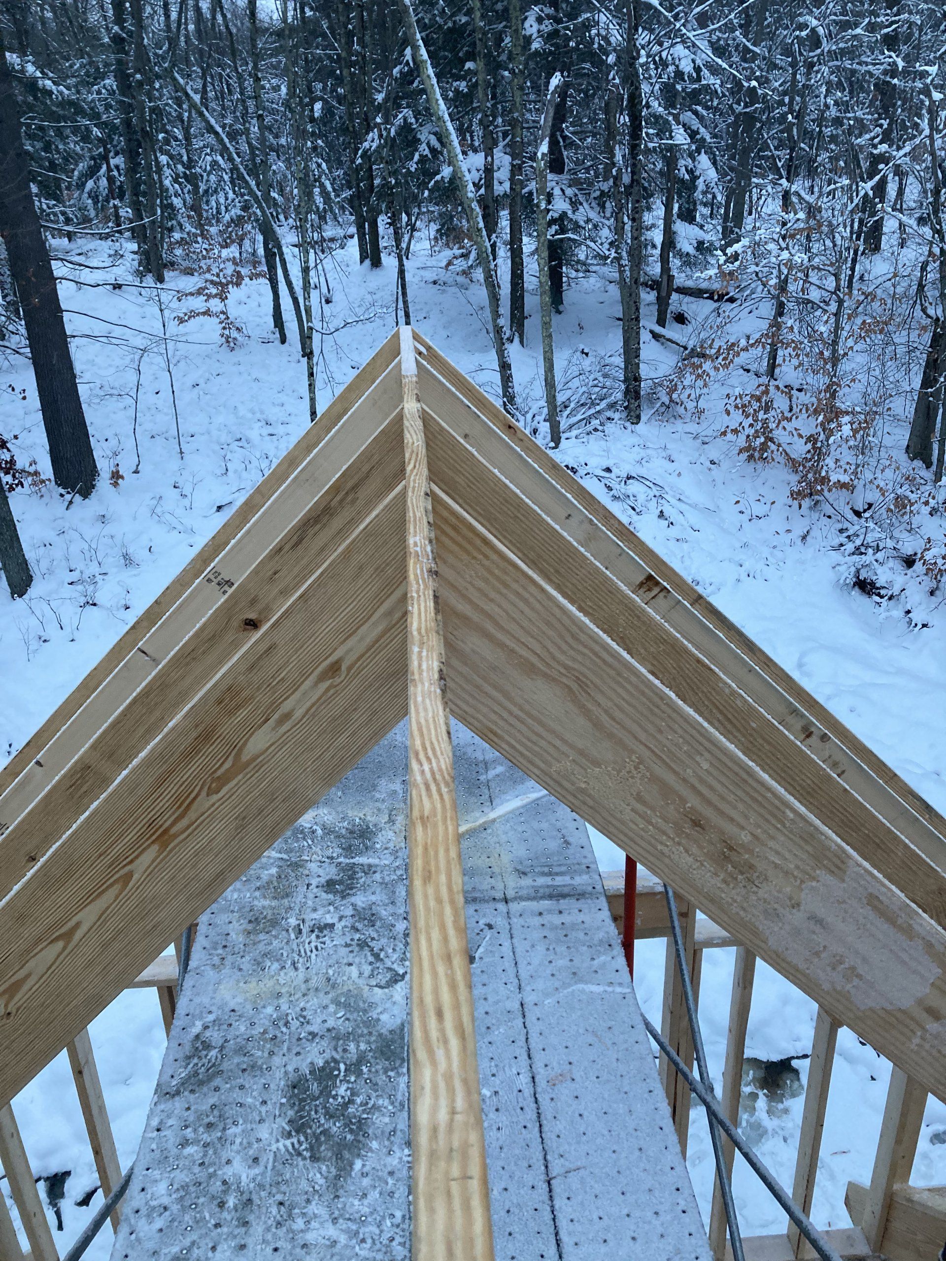 A wooden structure is being built in the snow