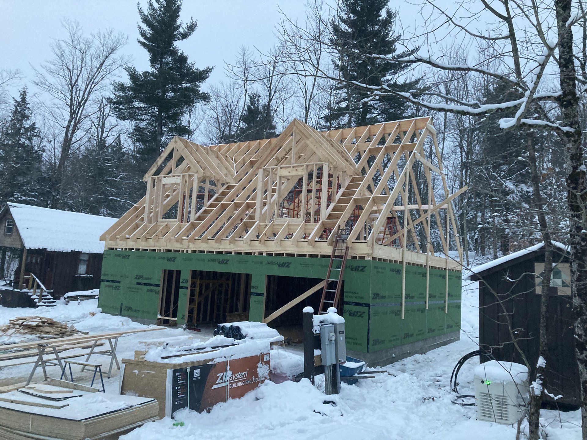 A house is being built in the snow in the woods.