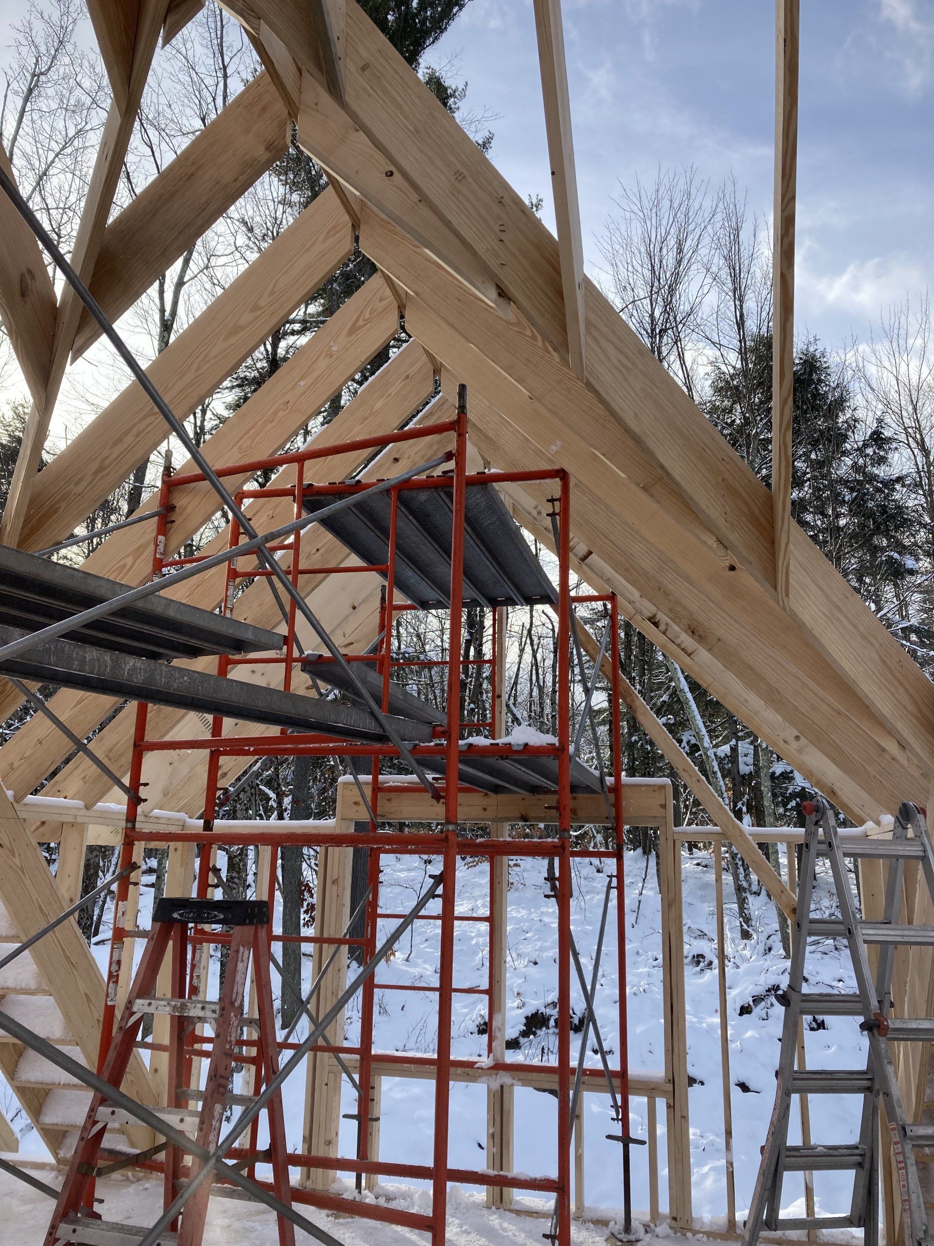 A wooden structure is being built in the snow