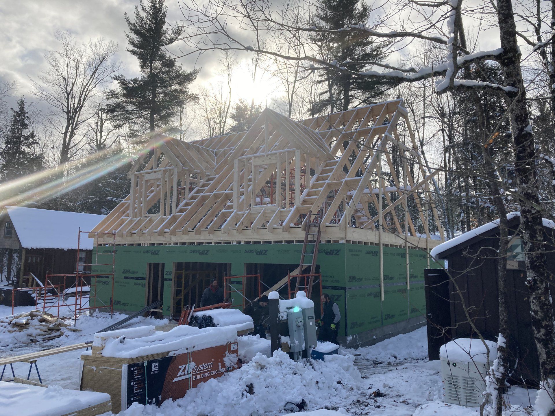 A house is being built in the snow in the woods.
