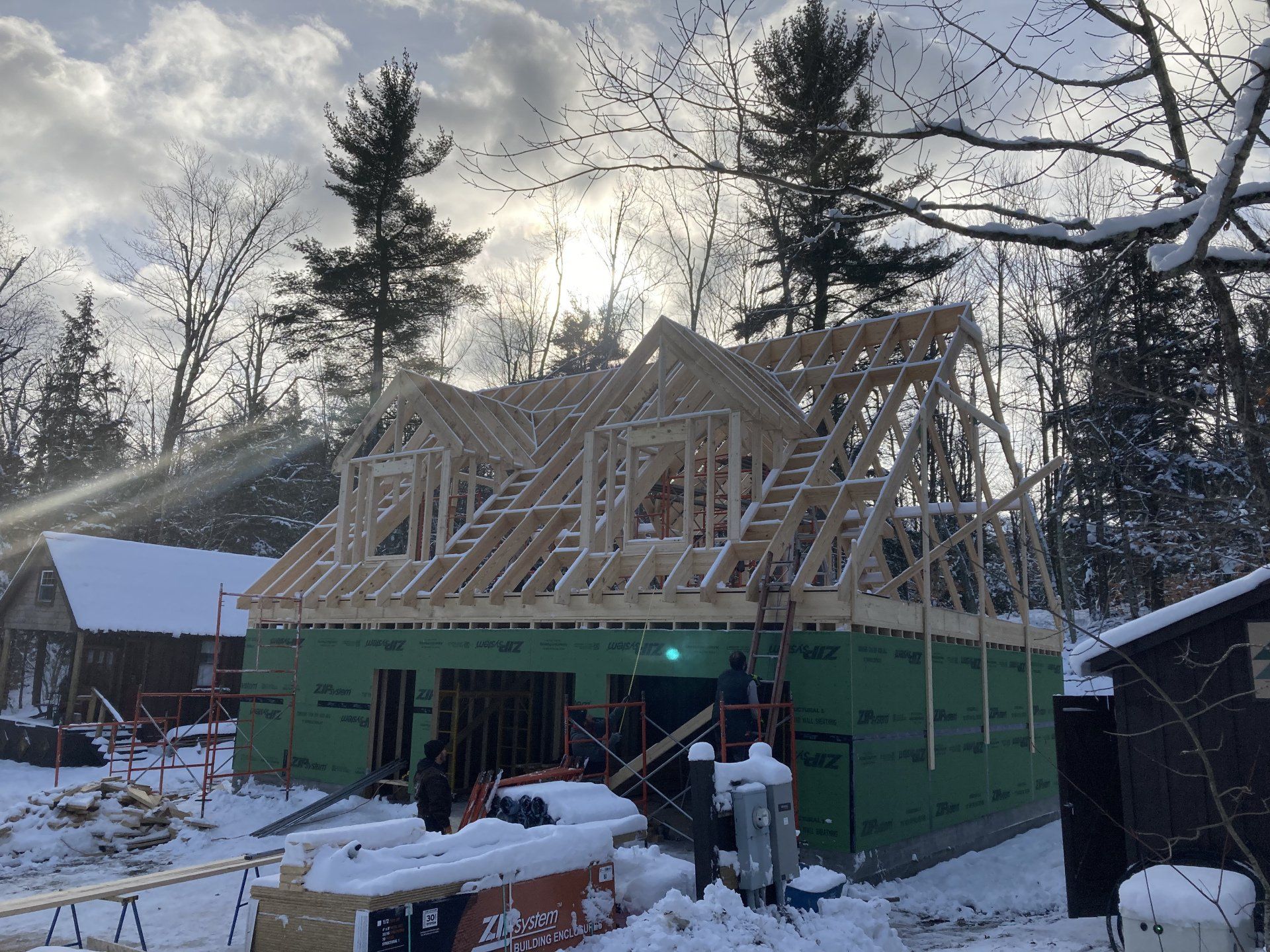 A house is being built in the snow in the woods.
