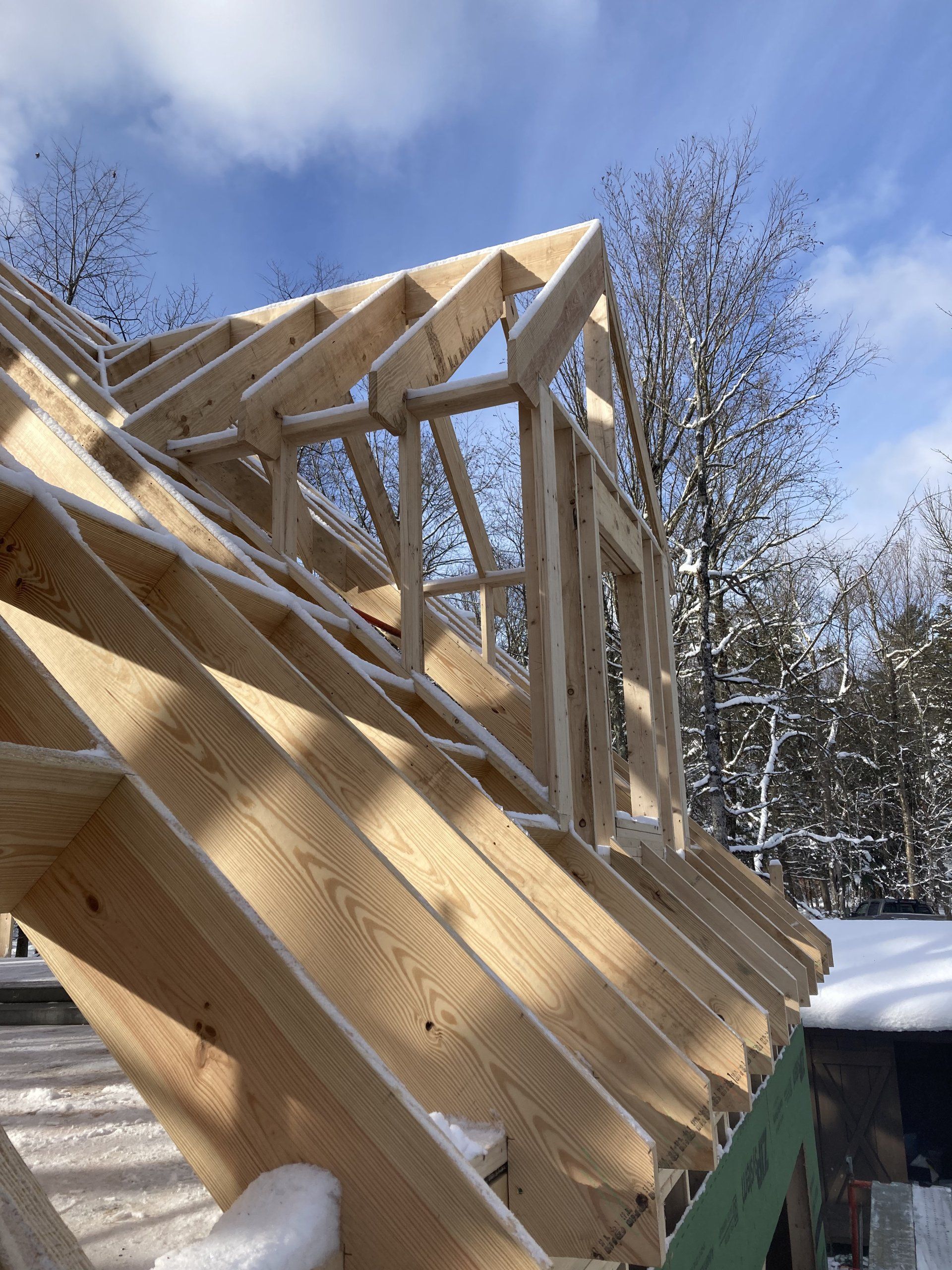 A wooden structure is being built in the snow.