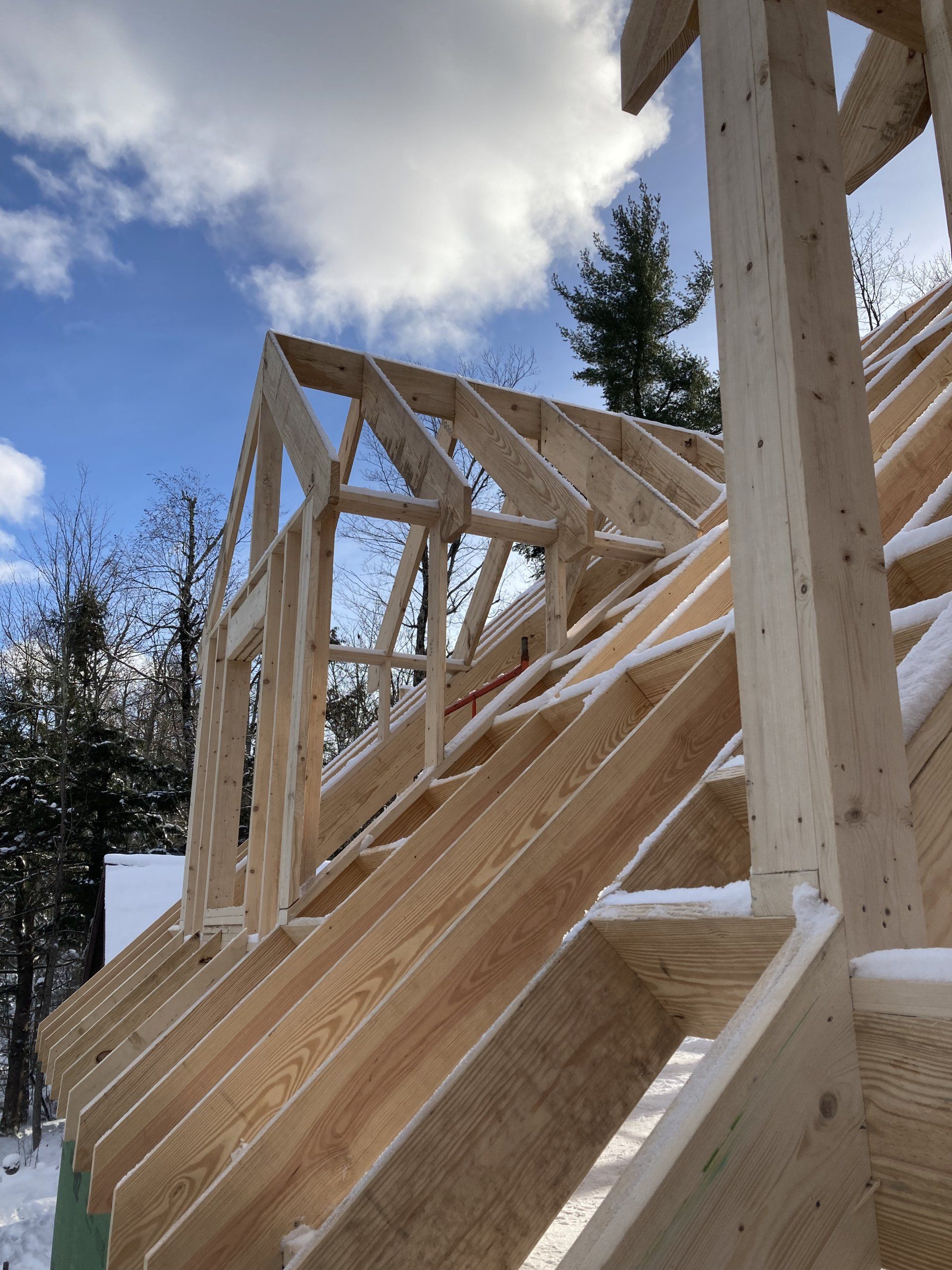 A wooden structure is being built in the snow.