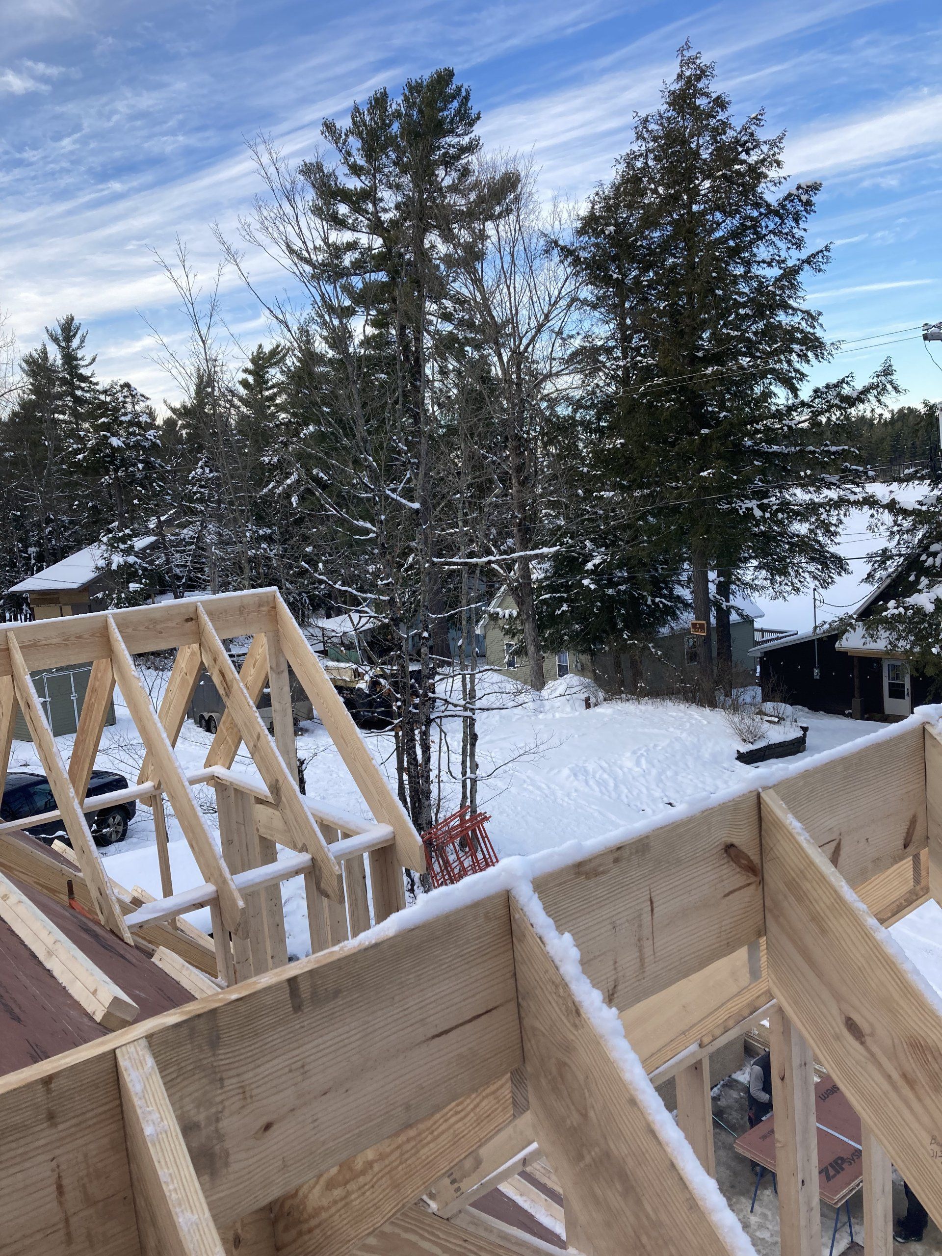 A wooden structure is being built in the snow.