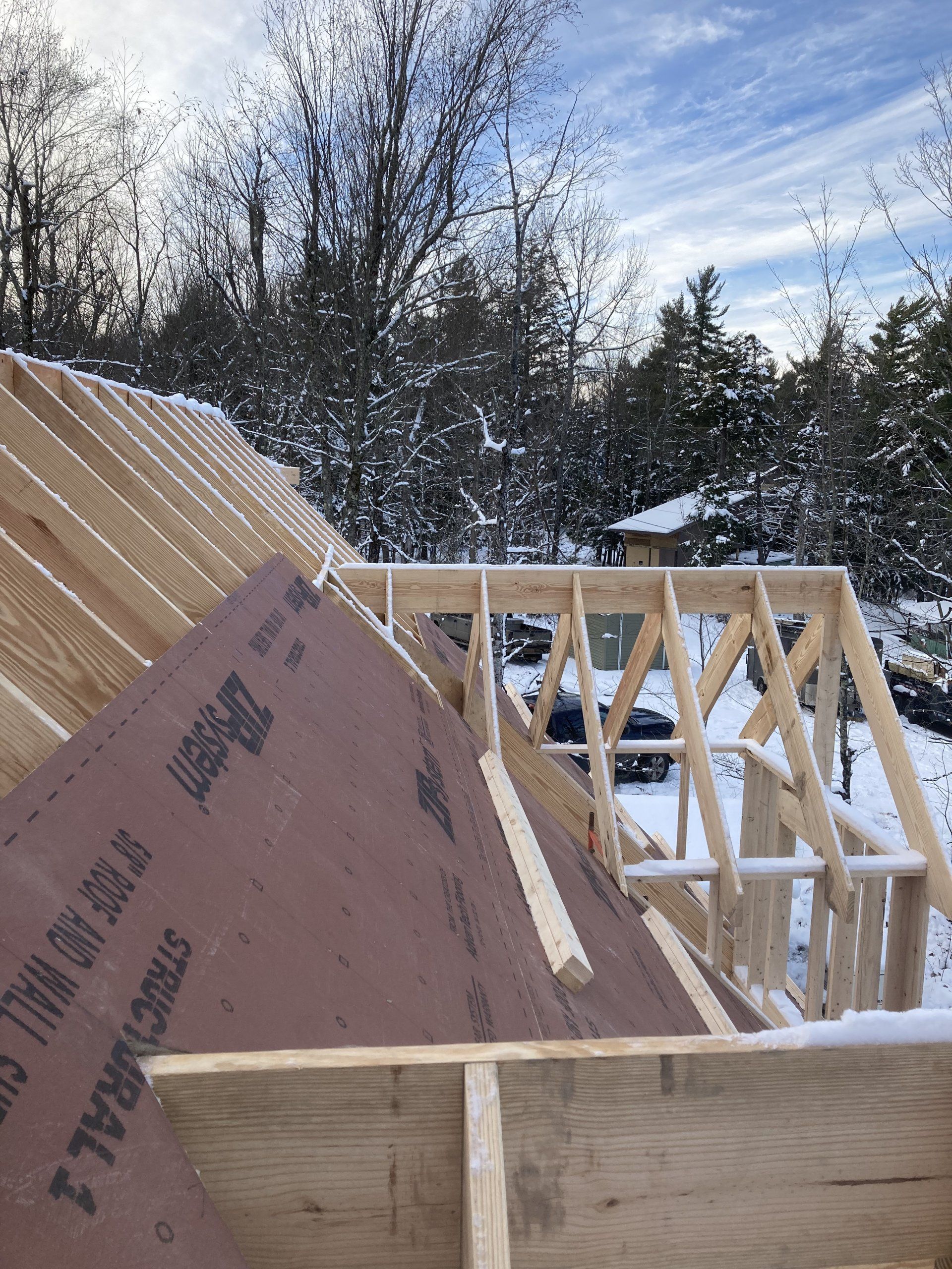 A wooden structure is being built in the snow.