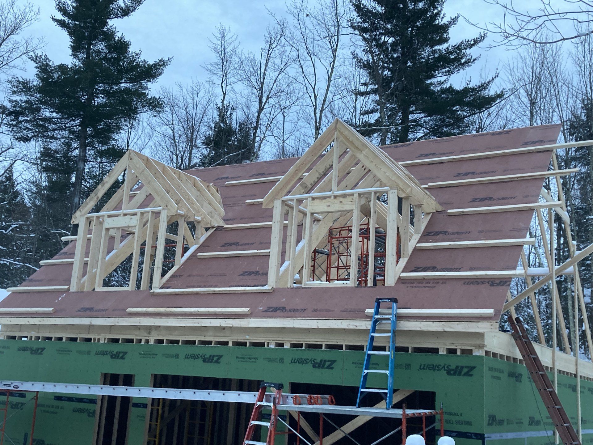 A house is being built with a roof that is being built.