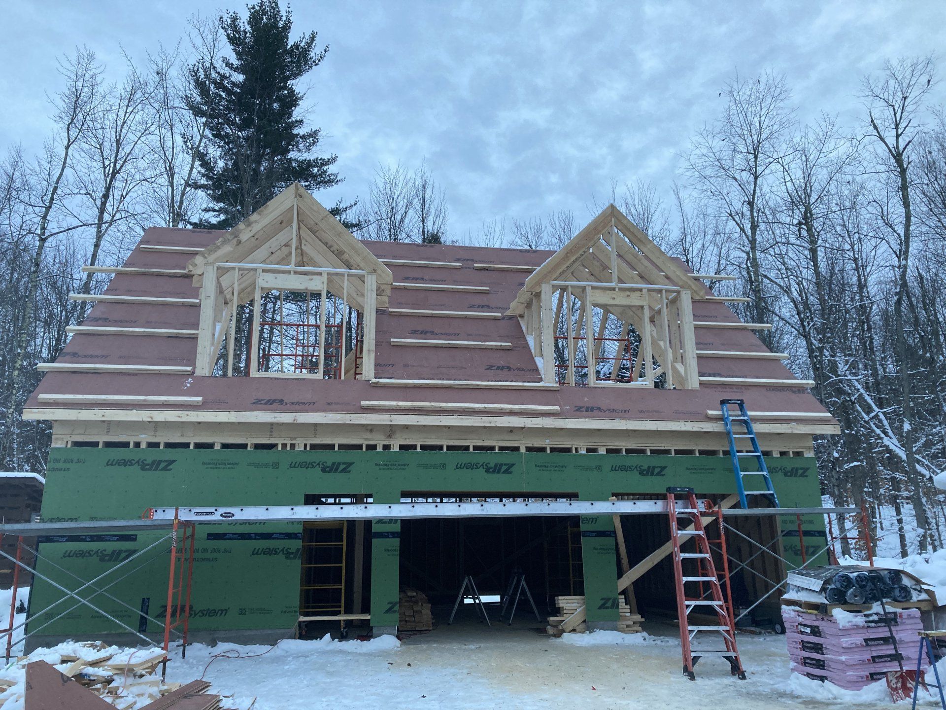 A house that is being built with a red roof