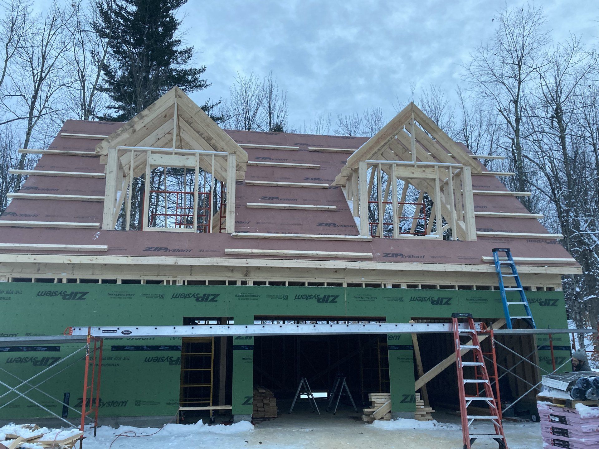 A house that is being built with a red roof