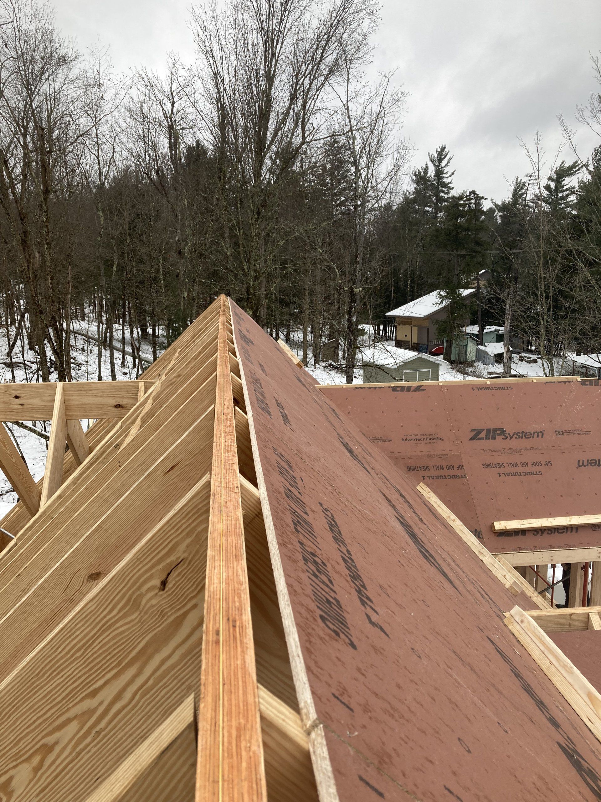 A wooden roof is being built in the snow.