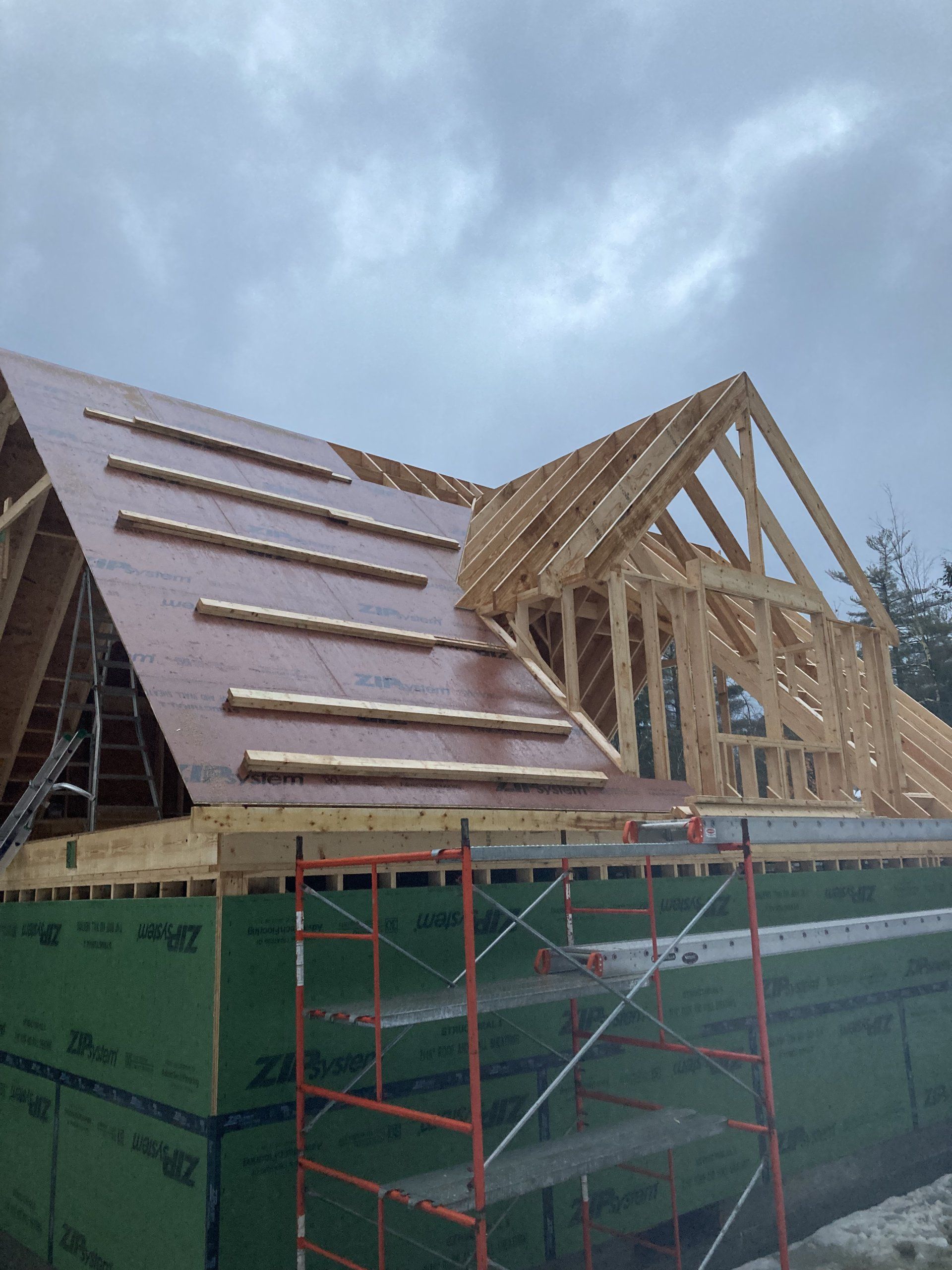 A house is being built and the roof is being installed.