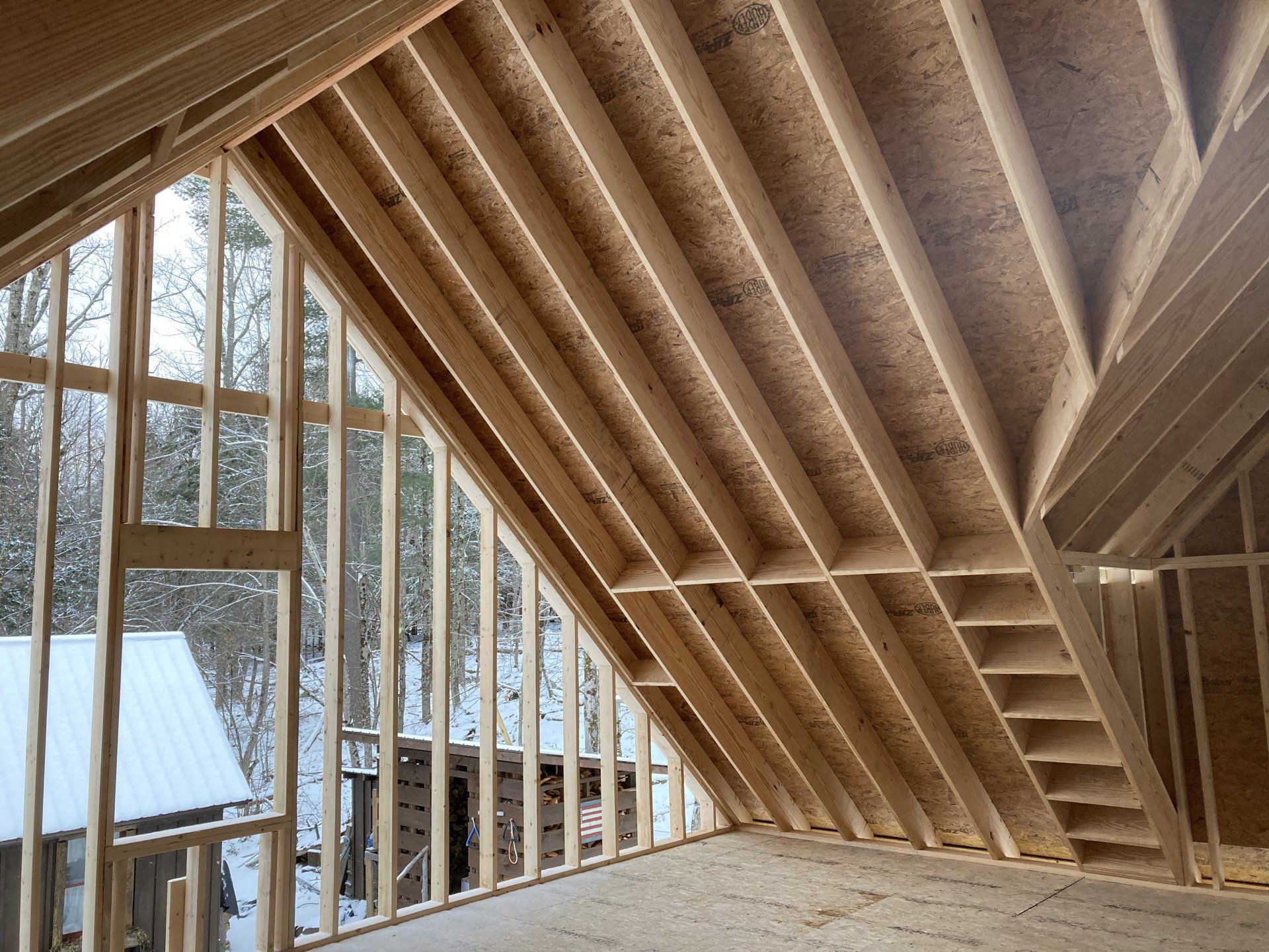 The inside of a house under construction with a lot of windows