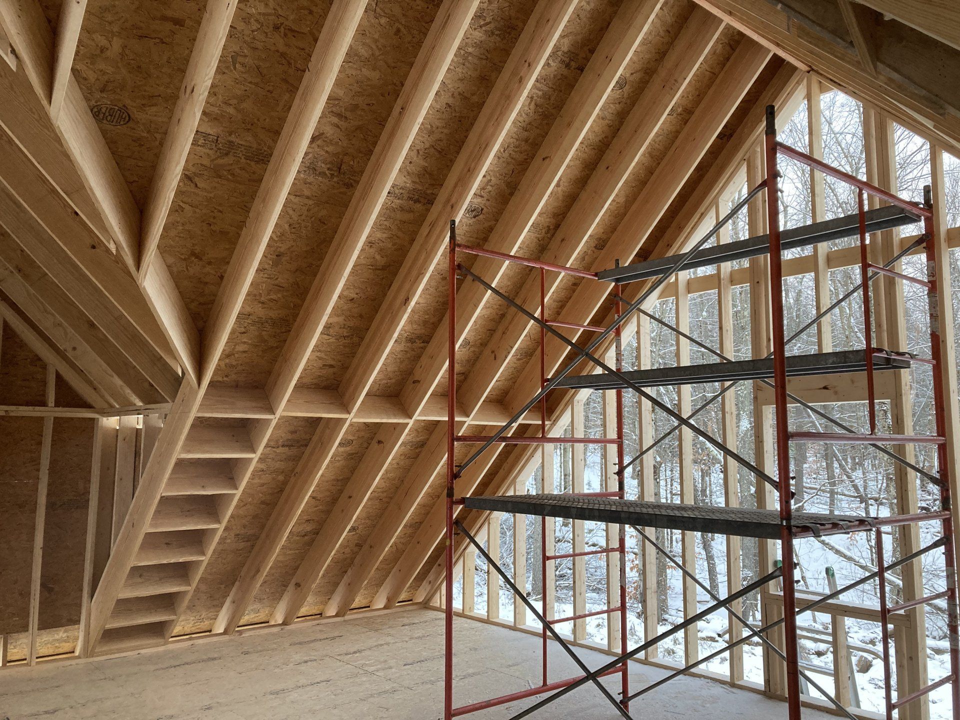 A room under construction with a scaffolding and stairs