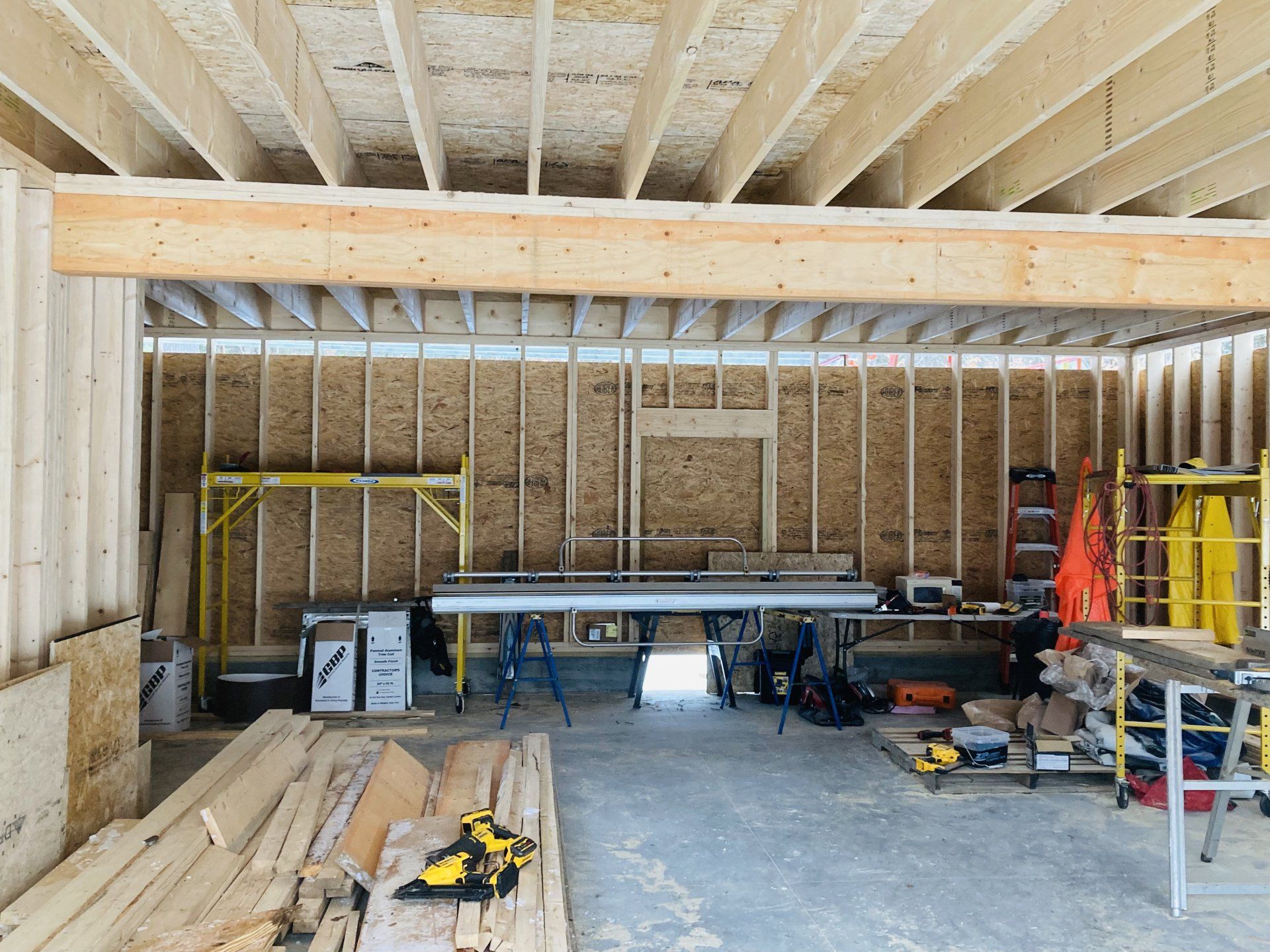 A building under construction with a lot of wood and tools.
