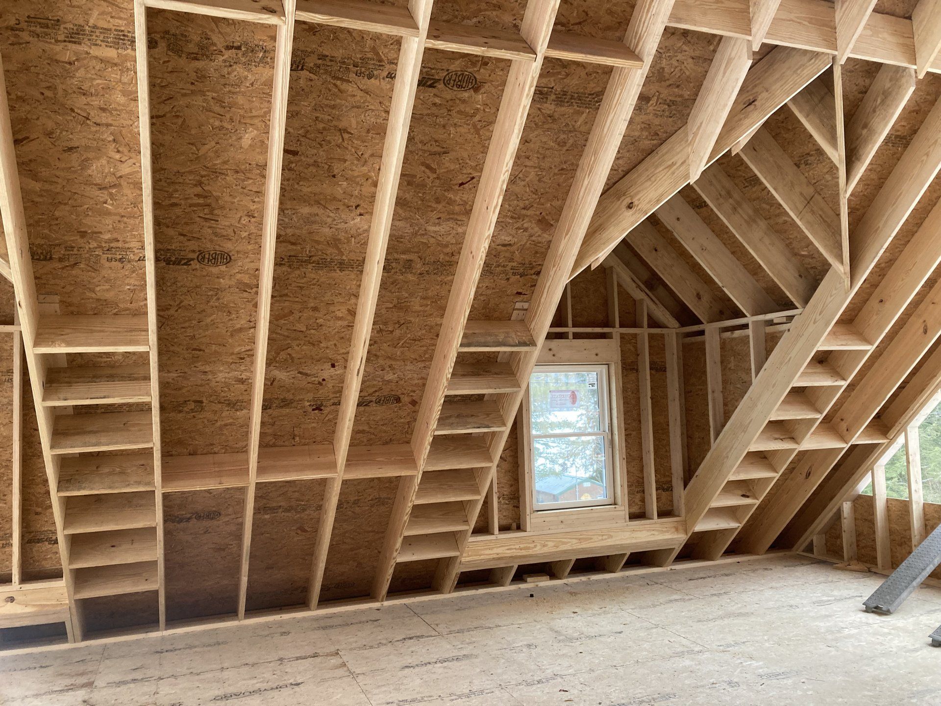 A room under construction with a window and stairs