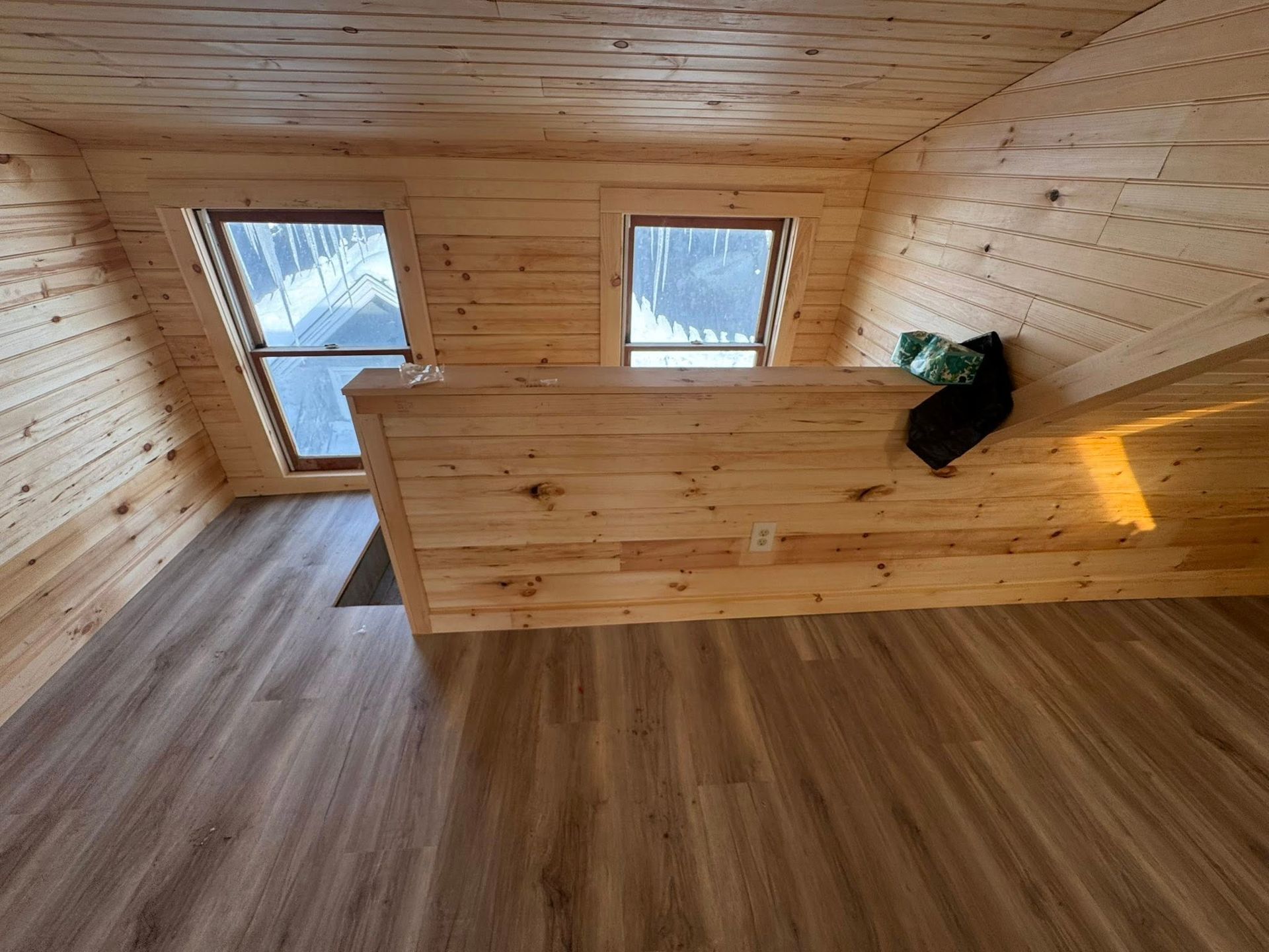 A man is standing next to a blue tarp on a construction site.