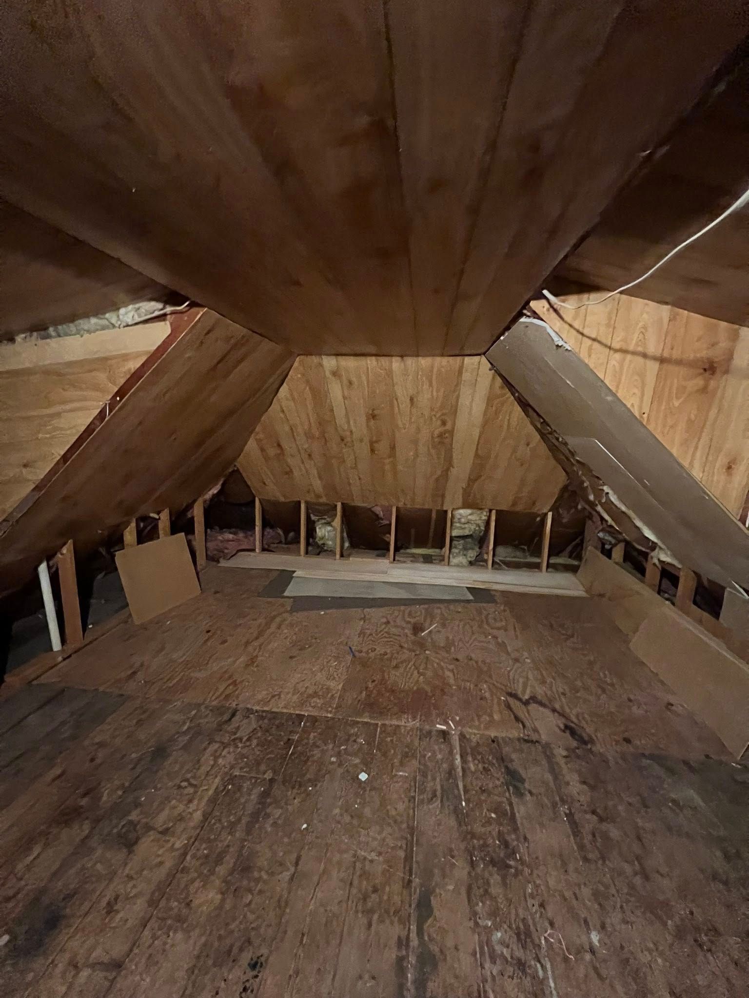 A small house with a wooden siding and a window.