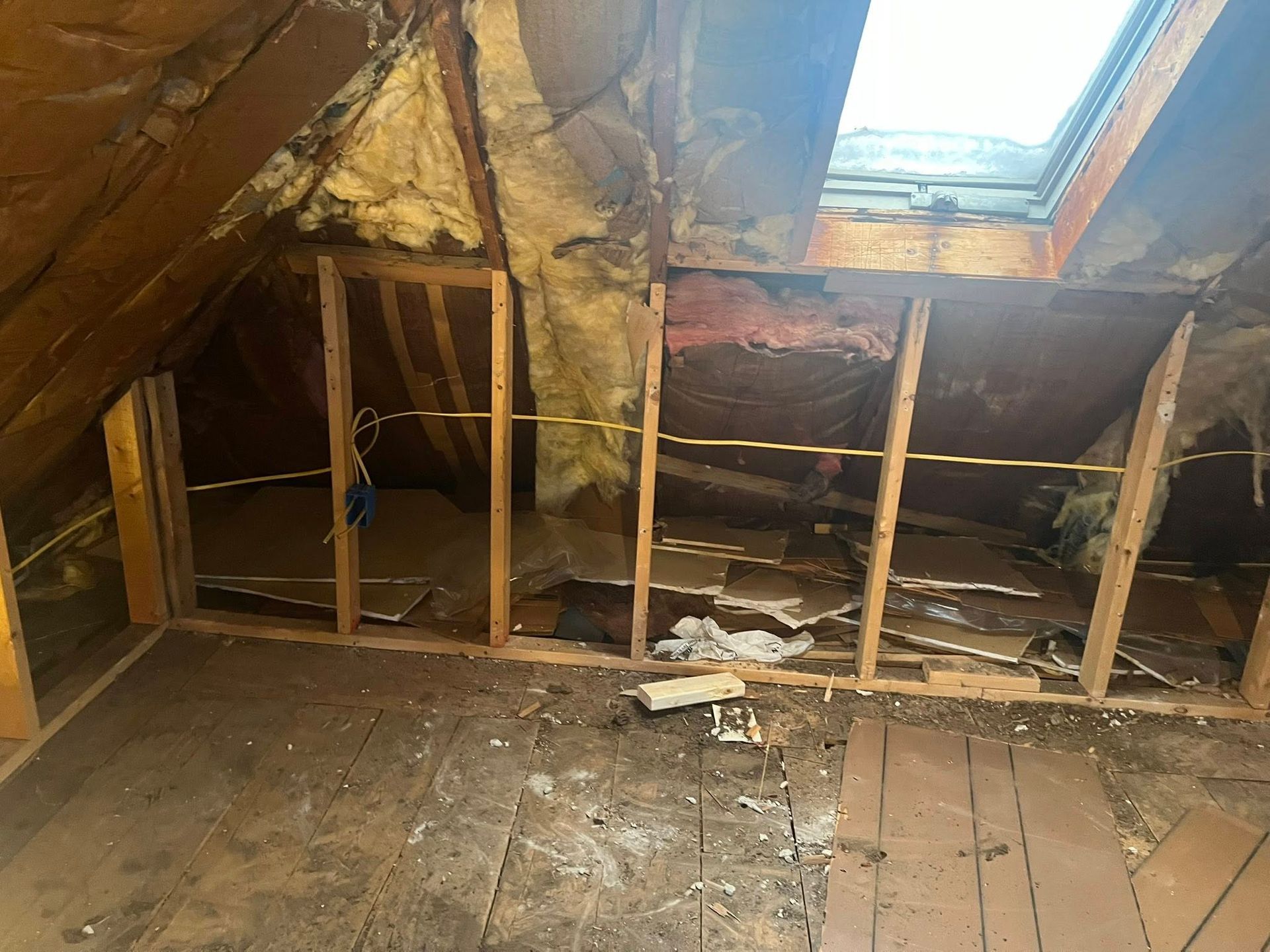 A small wooden shed with a window and a roof is being built.