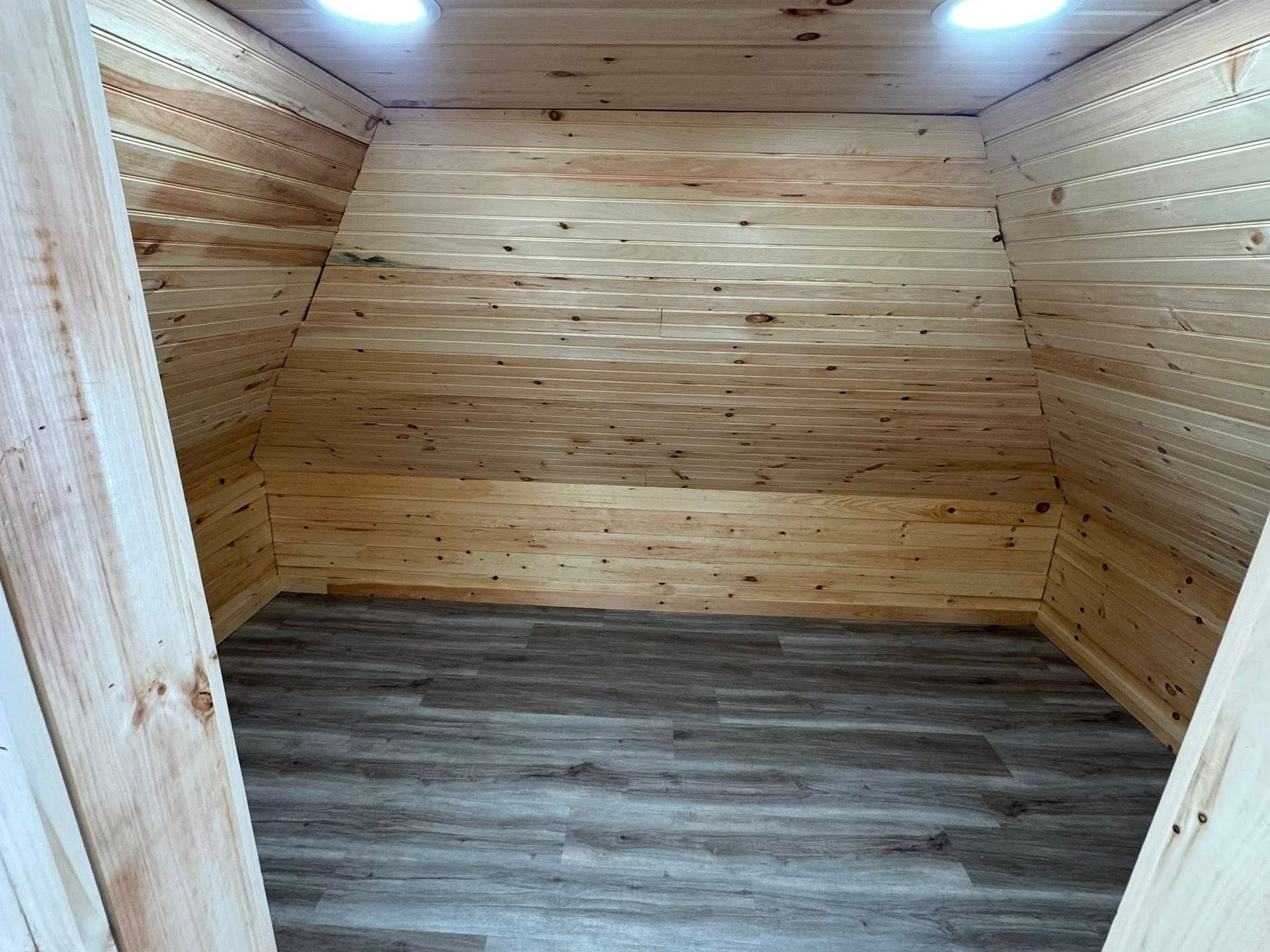 A wooden house is being built with a green wall and a white door.